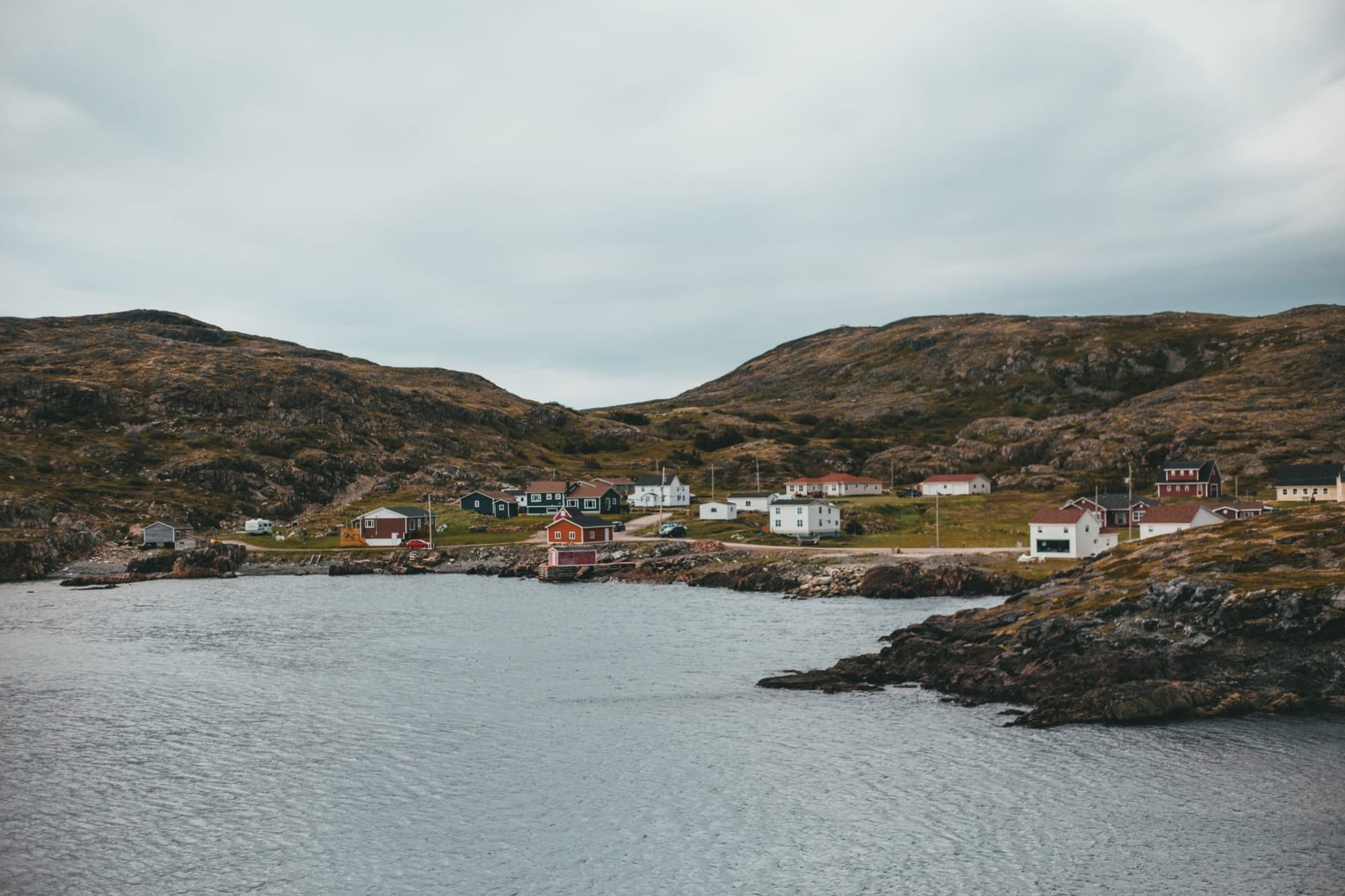 Rows of brightly painted Victorian rowhouses on a hillside above St. John's harbour, Newfoundland