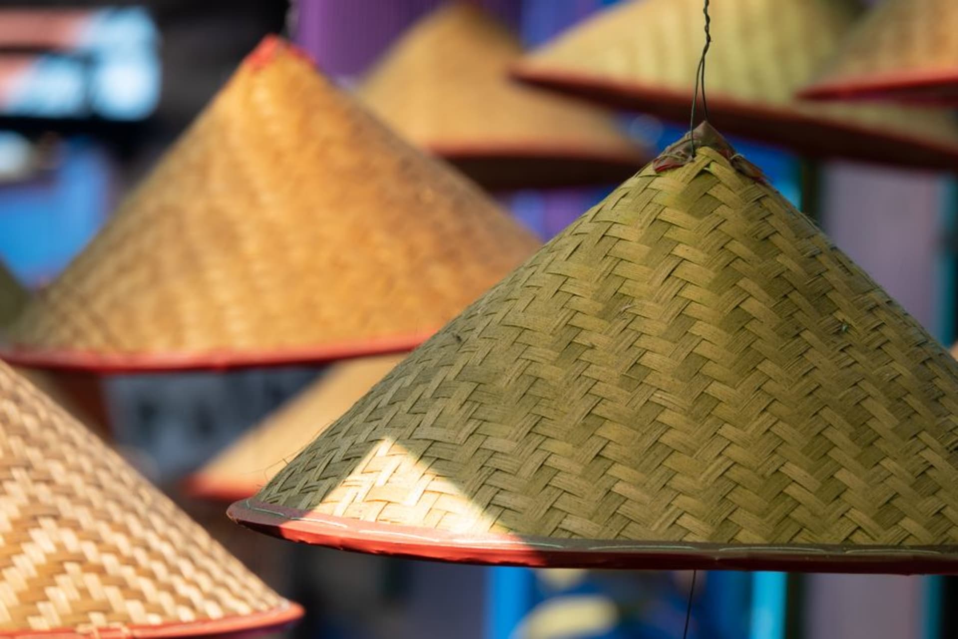 Rows of handwoven palm-fiber hats hanging outside a workshop in Camoapa