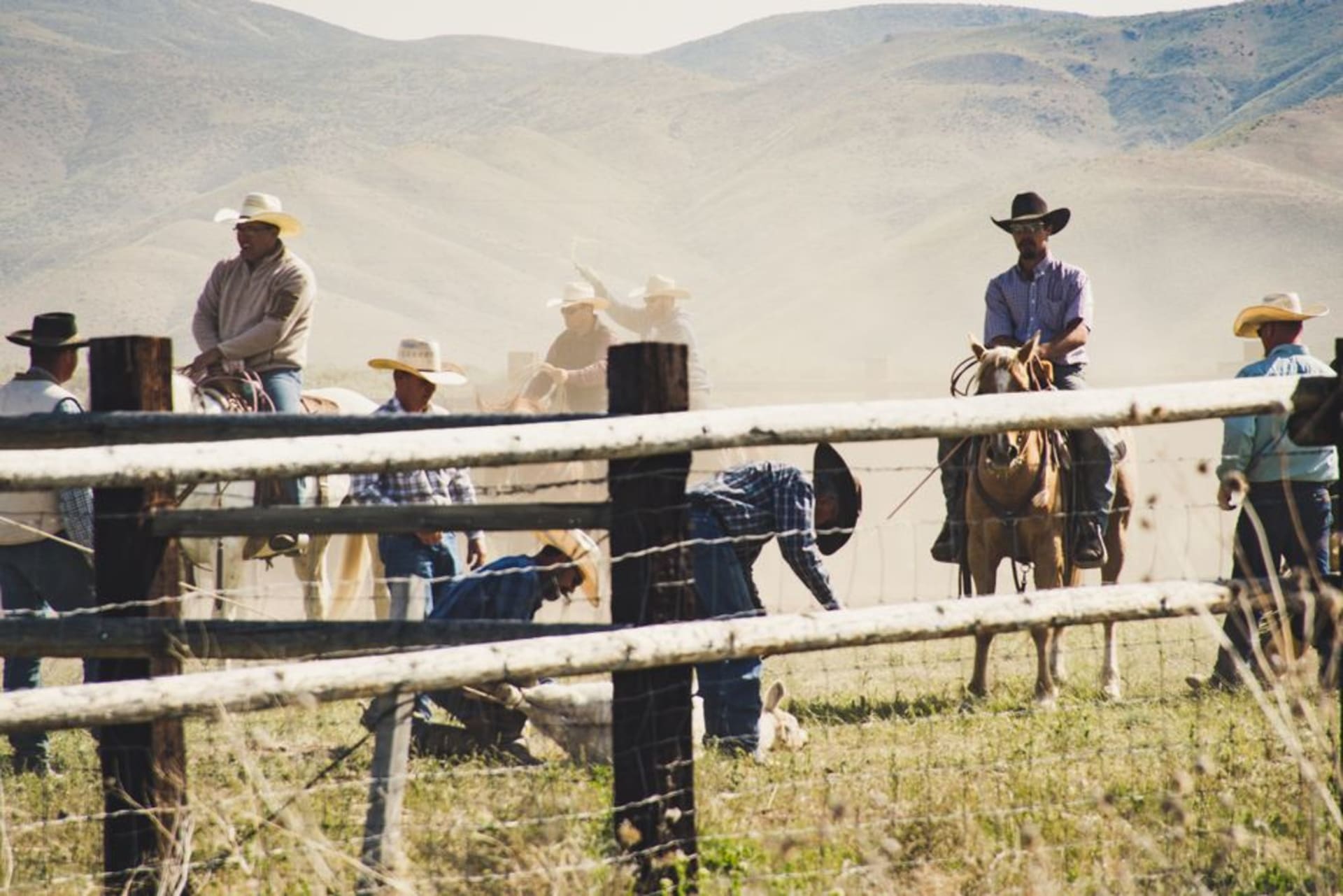 Cattle ranchers on horseback riding through the streets of Juigalpa at dawn