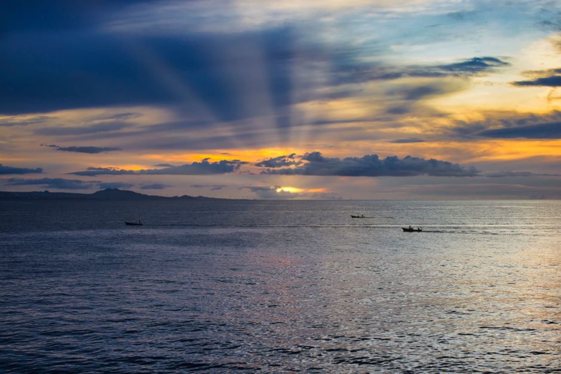 Fishing boats moored along the calm waters of Pearl Lagoon at sunset