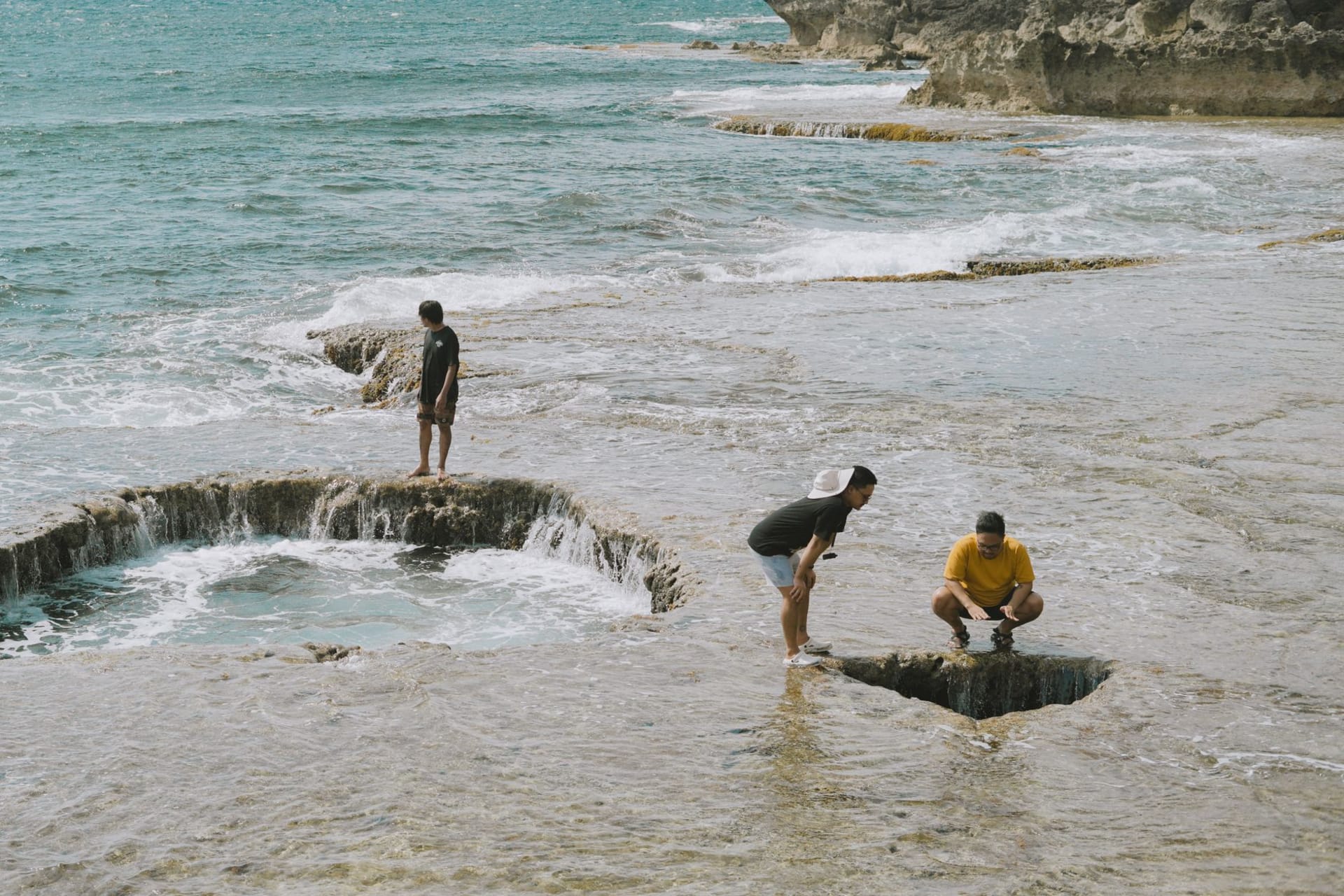 The Limu natural rock pools along Niue's west coast, turquoise water filling coral limestone formations at sunset