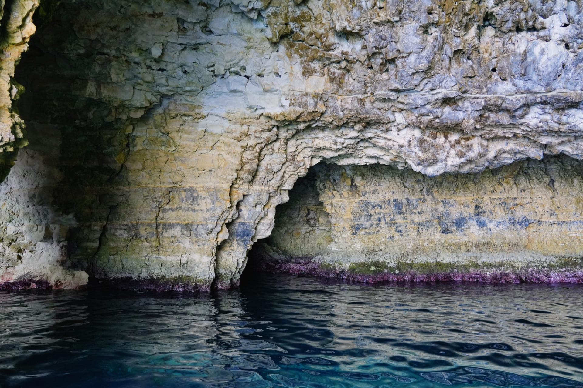 Des stalactites suspendues au plafond de la Grotte de Palaha au-dessus d'une piscine marine turquoise resplendissante, Niue