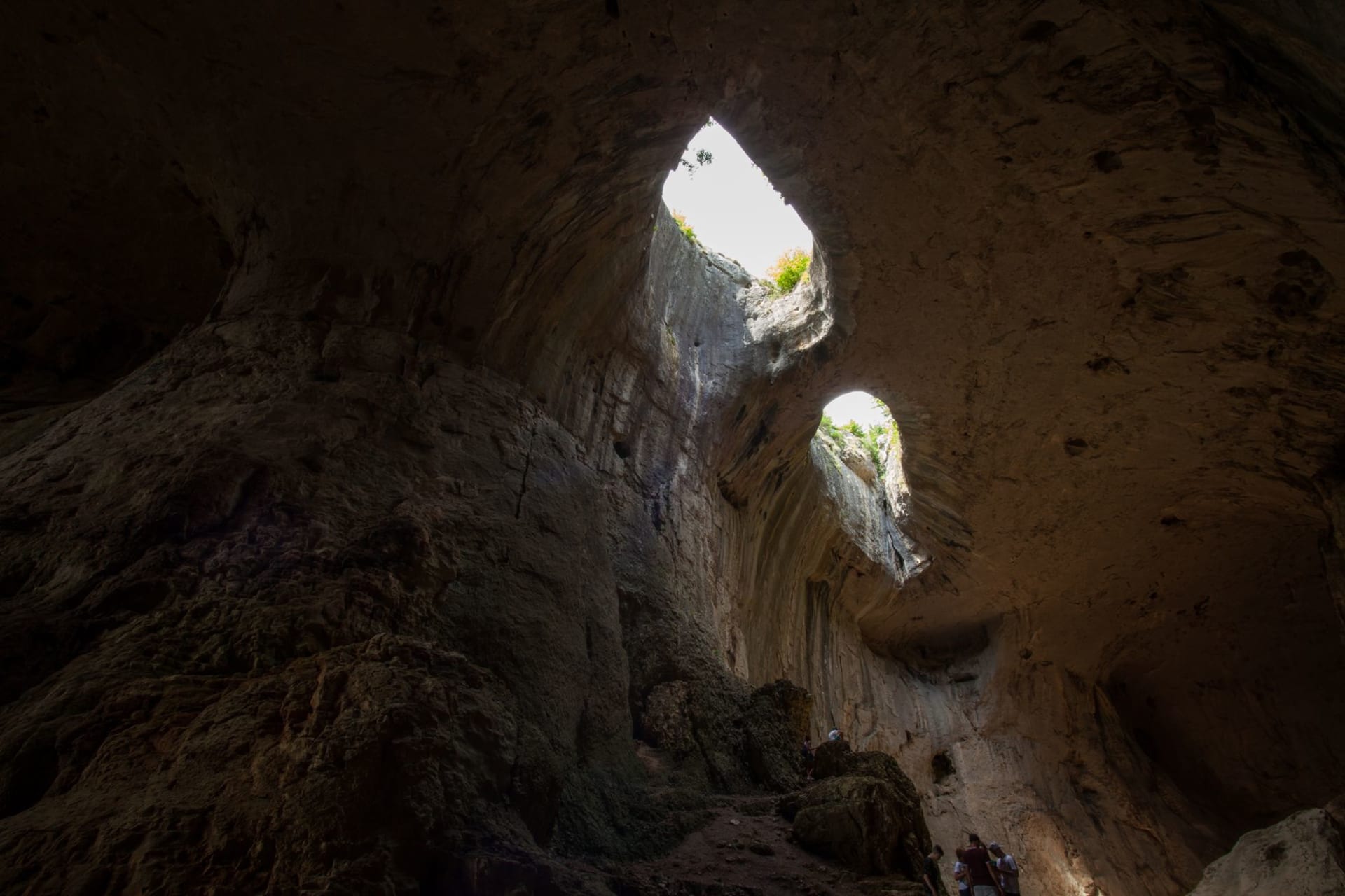 The twin limestone arches of Talava framing a turquoise sea passage on Niue's northern coast