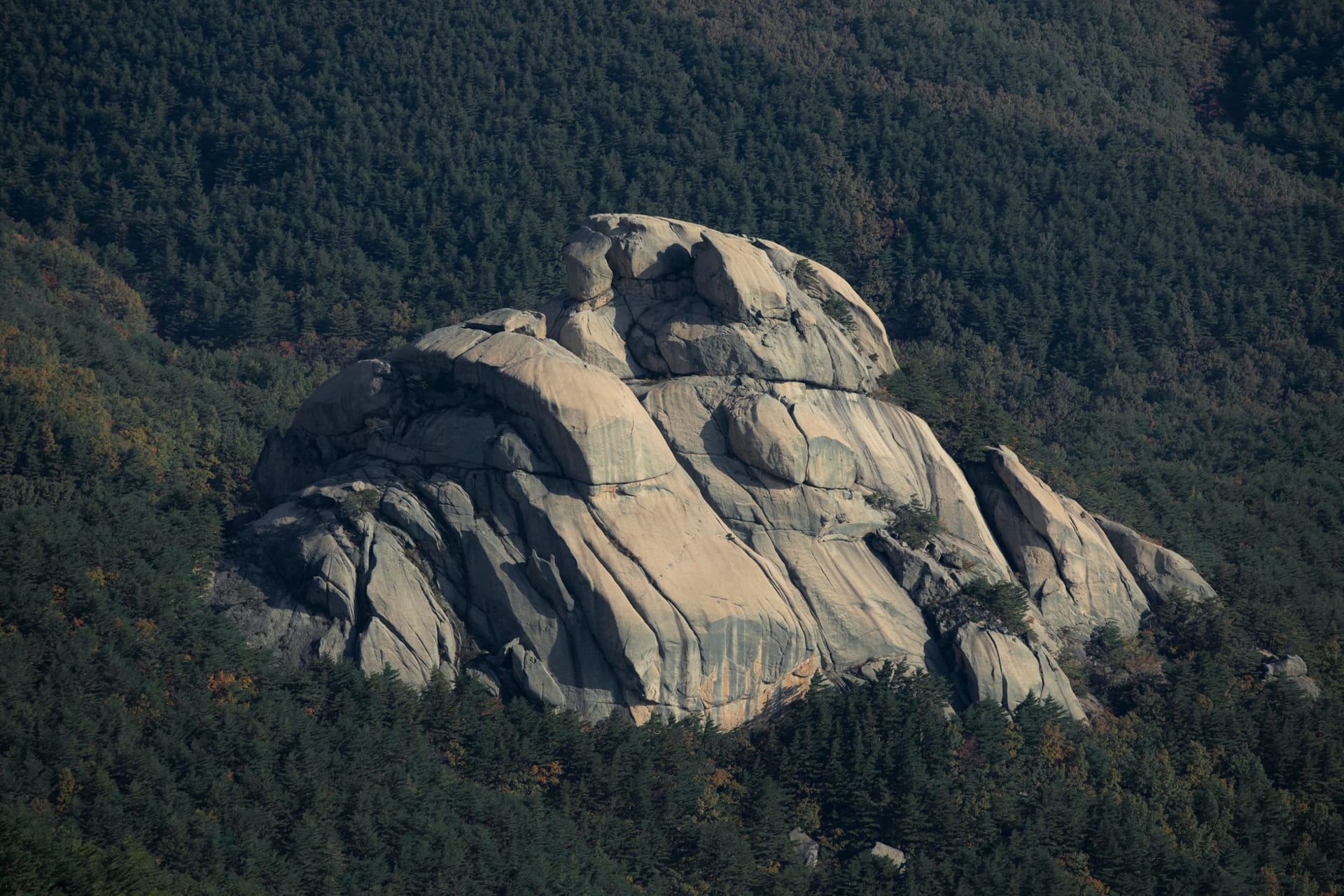 Jagged eroded rock pinnacles of Outer Chilbo rising above autumn forest, North Hamgyong, North Korea