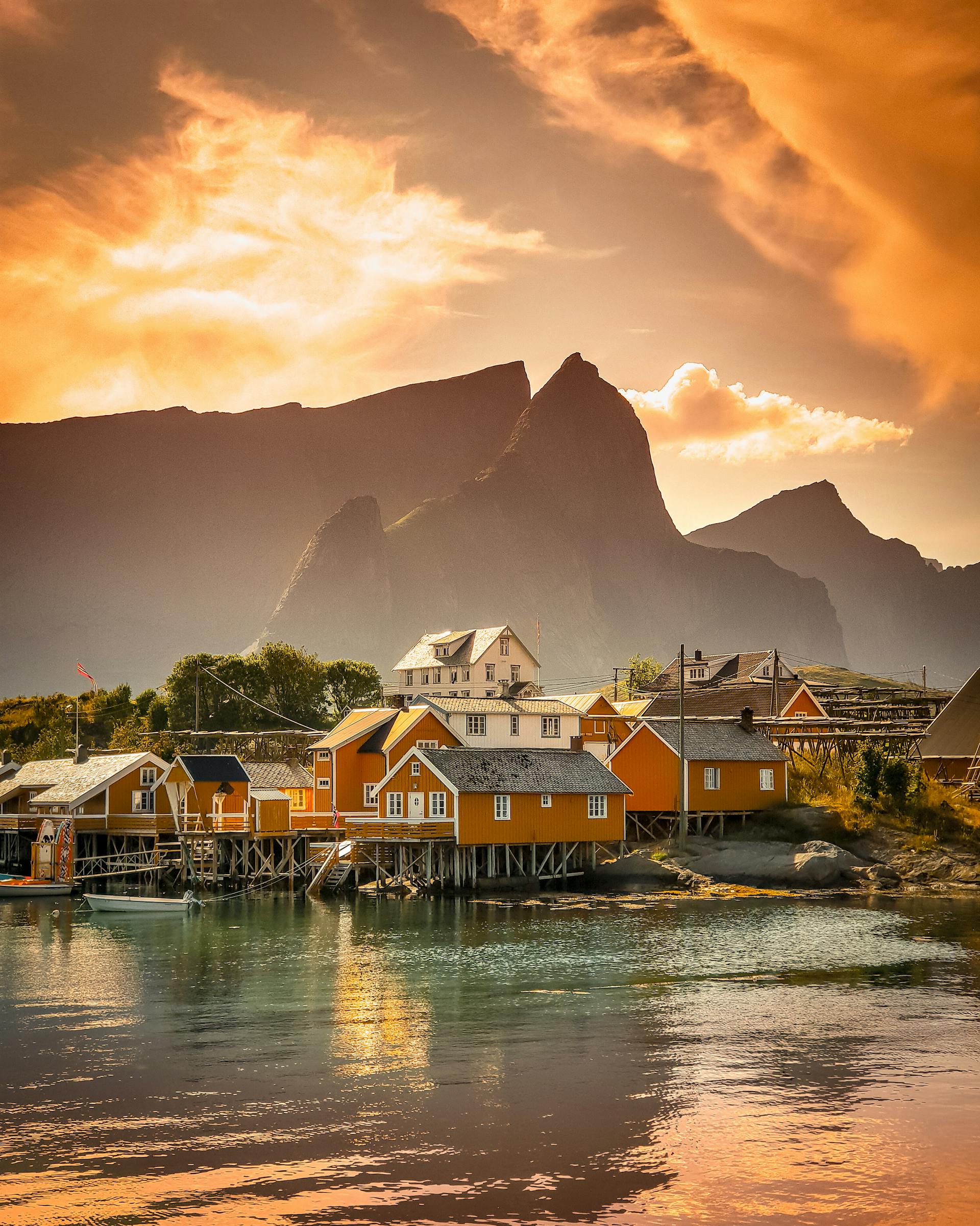 Art Nouveau buildings of Alesund harbour with colourful facades and mountain backdrop