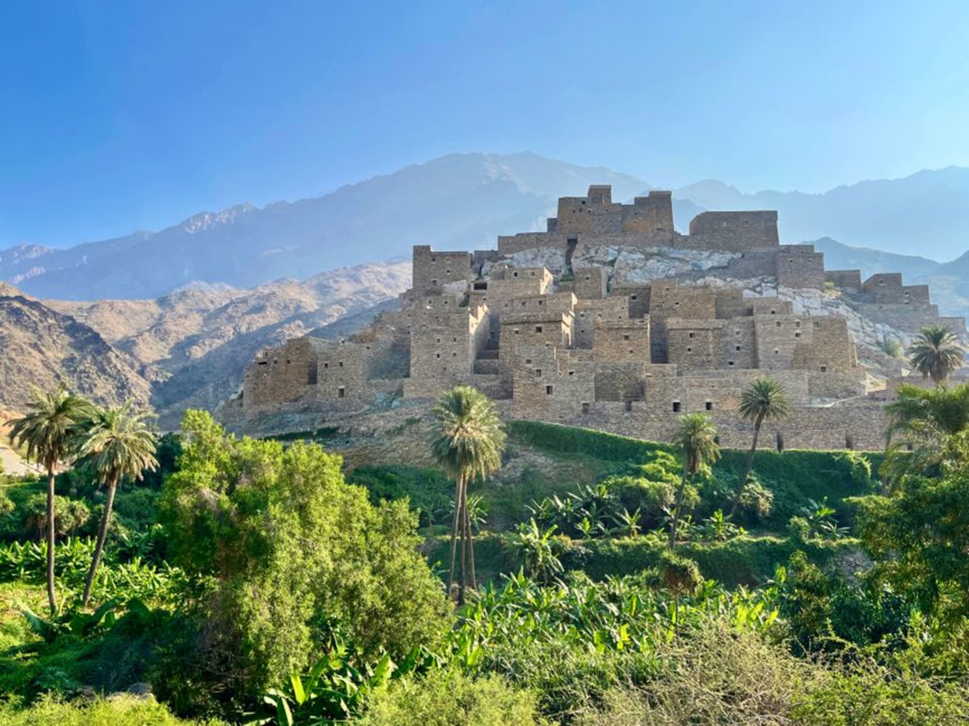 Ruins of the ancient port city of Al Baleed with the Frankincense Land Museum and palm trees along the Salalah coastline, Oman