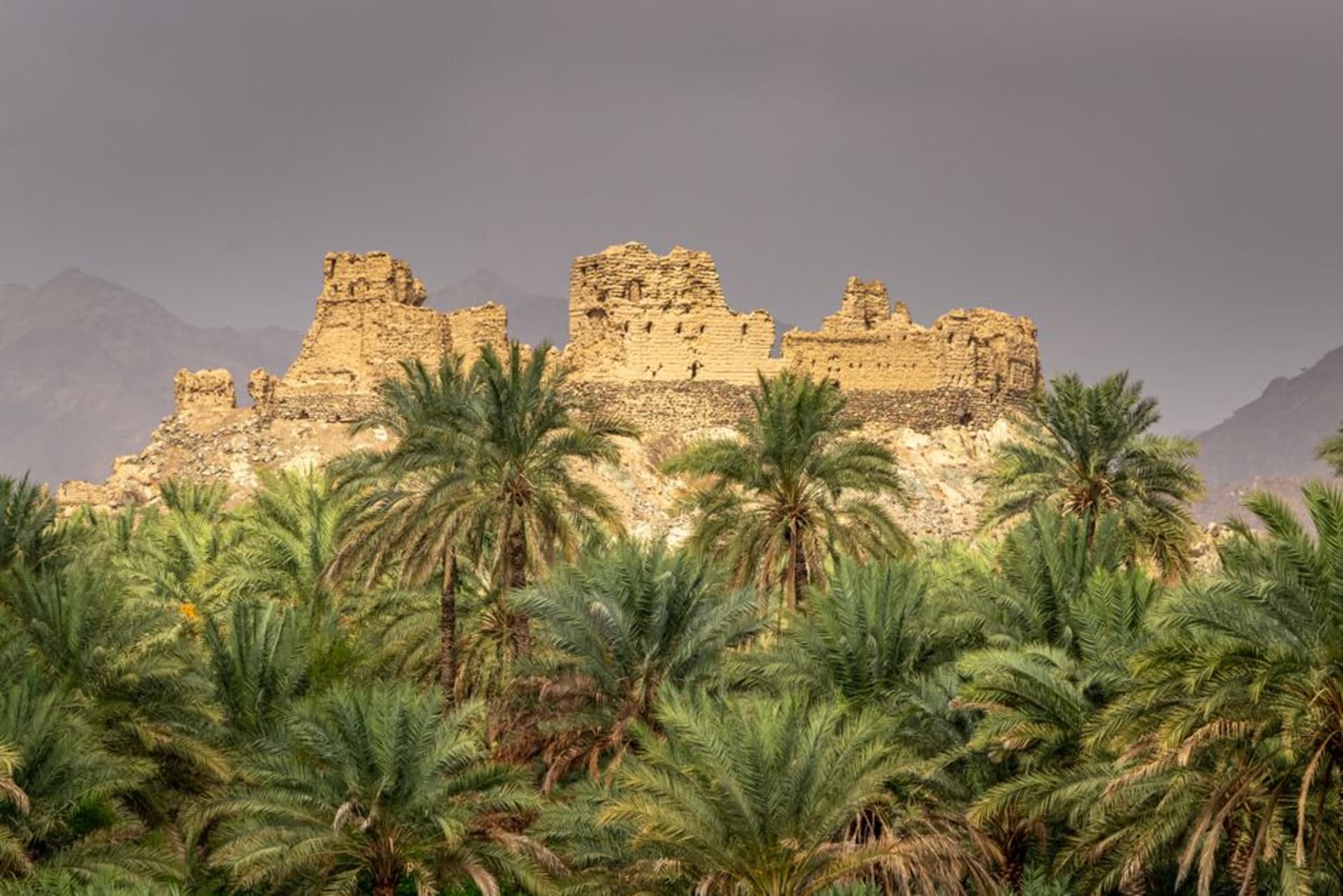 Ruins of the ancient city of Sumhuram at Khor Rori overlooking a turquoise lagoon in Dhofar, Oman