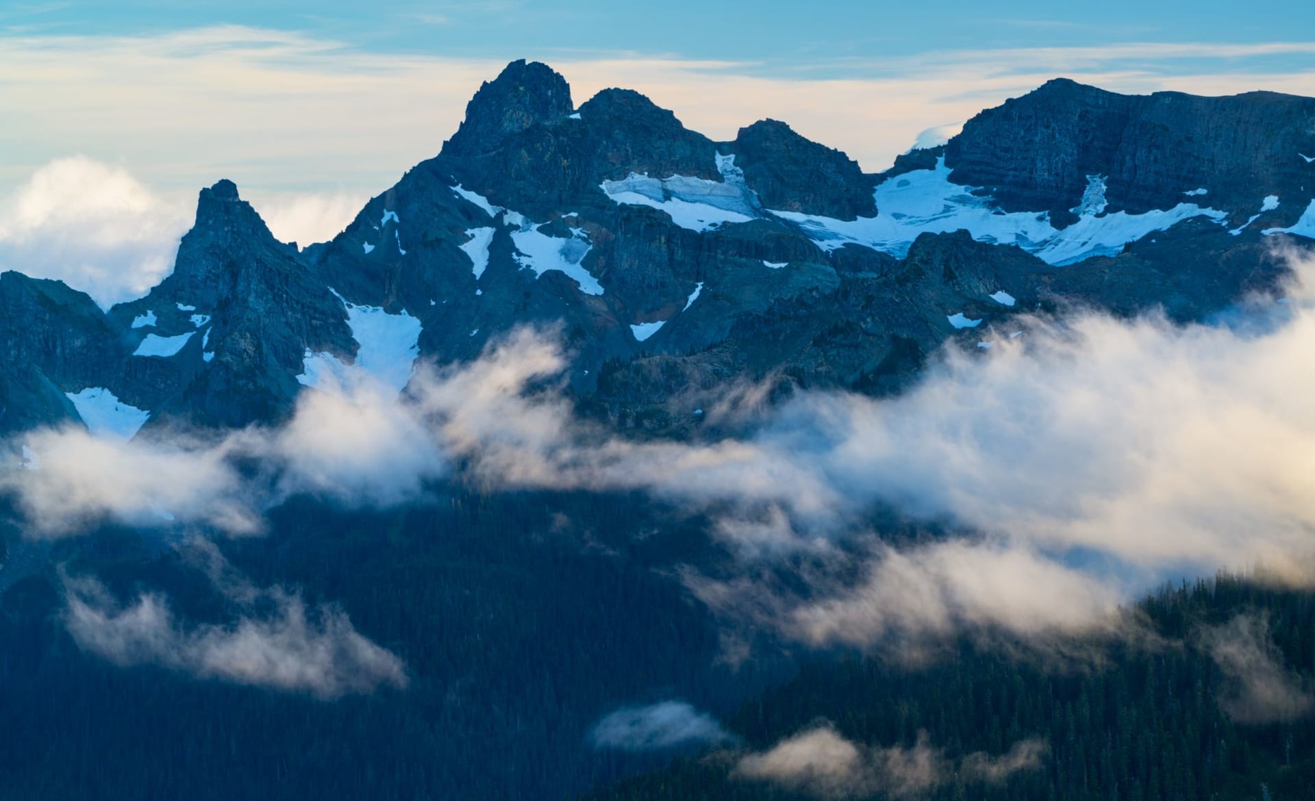 Jagged glaciated peaks of the North Cascades reflected in a turquoise glacial lake, no trails or people visible, a wilderness of pure stone and ice