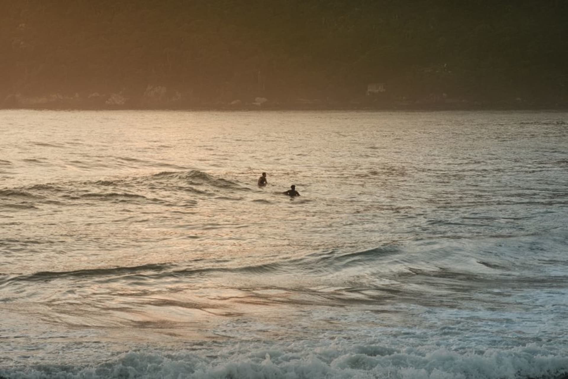 A long, powerful wave breaking over a rocky point at Santa Catalina with a surfer dropping in, Pacific coast of Panama.