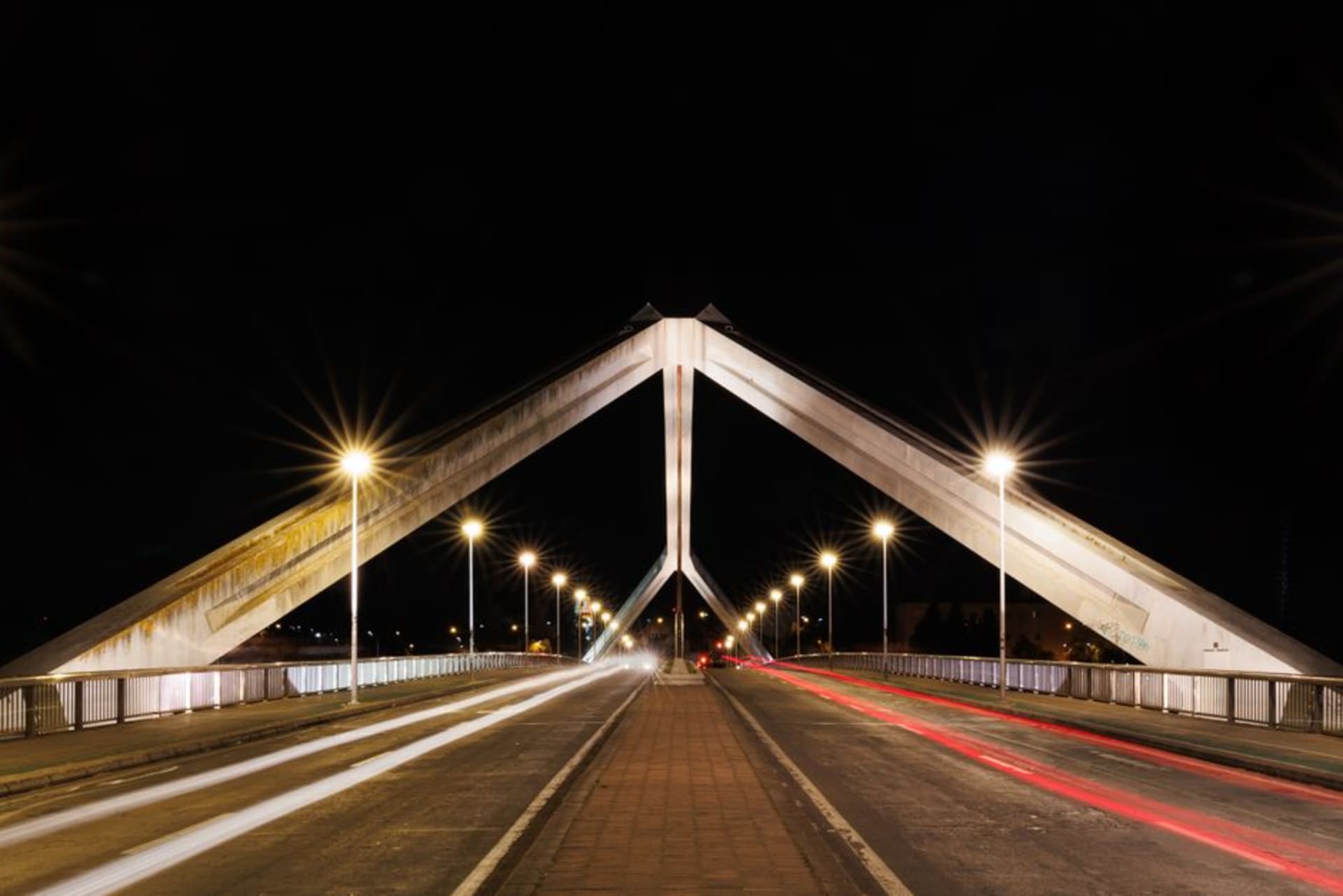 The raised dirt Transpantaneira road stretching through Pantanal wetlands with a wooden bridge in the foreground
