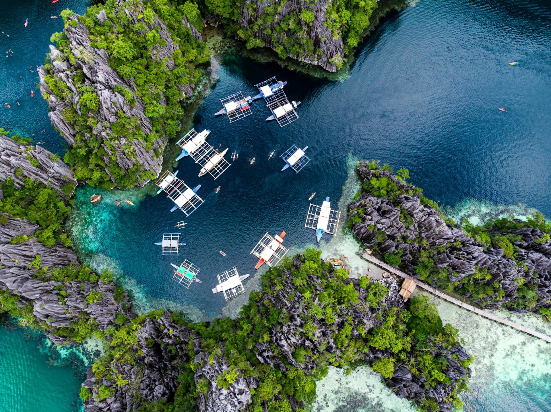Limestone karsts rising from emerald lagoon waters in El Nido's Bacuit Archipelago