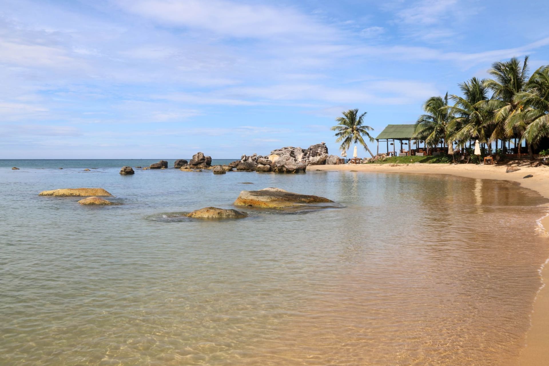 Bai Sao Beach with impossibly white sand curving into clear turquoise water lined by palm trees