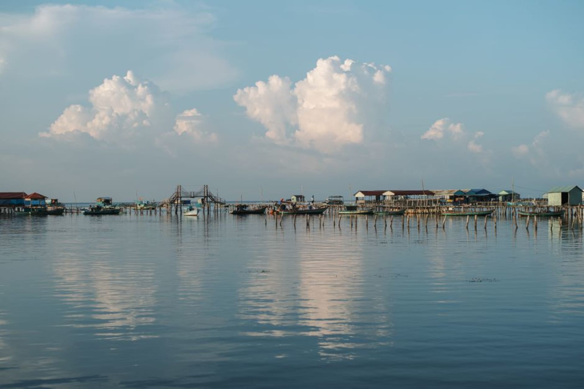 Wooden fishing boats moored along the Cửa Cạn River estuary at dawn