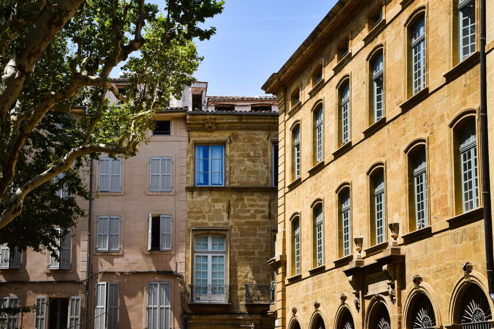 The tree-lined Cours Mirabeau boulevard in Aix-en-Provence with its mossy stone fountains and café terraces