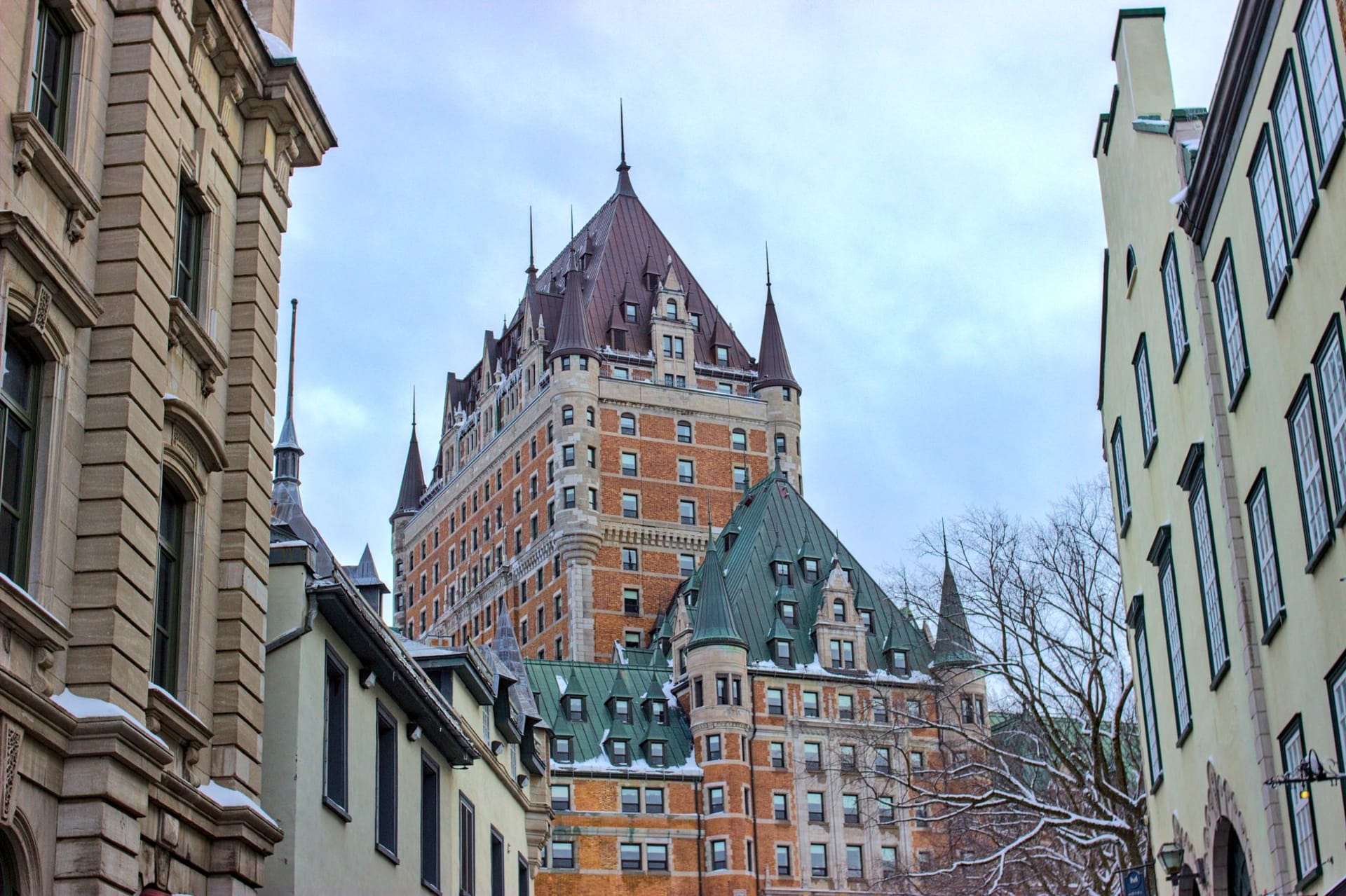 Château Frontenac rising above the snow-covered rooftops of Old Québec City in winter