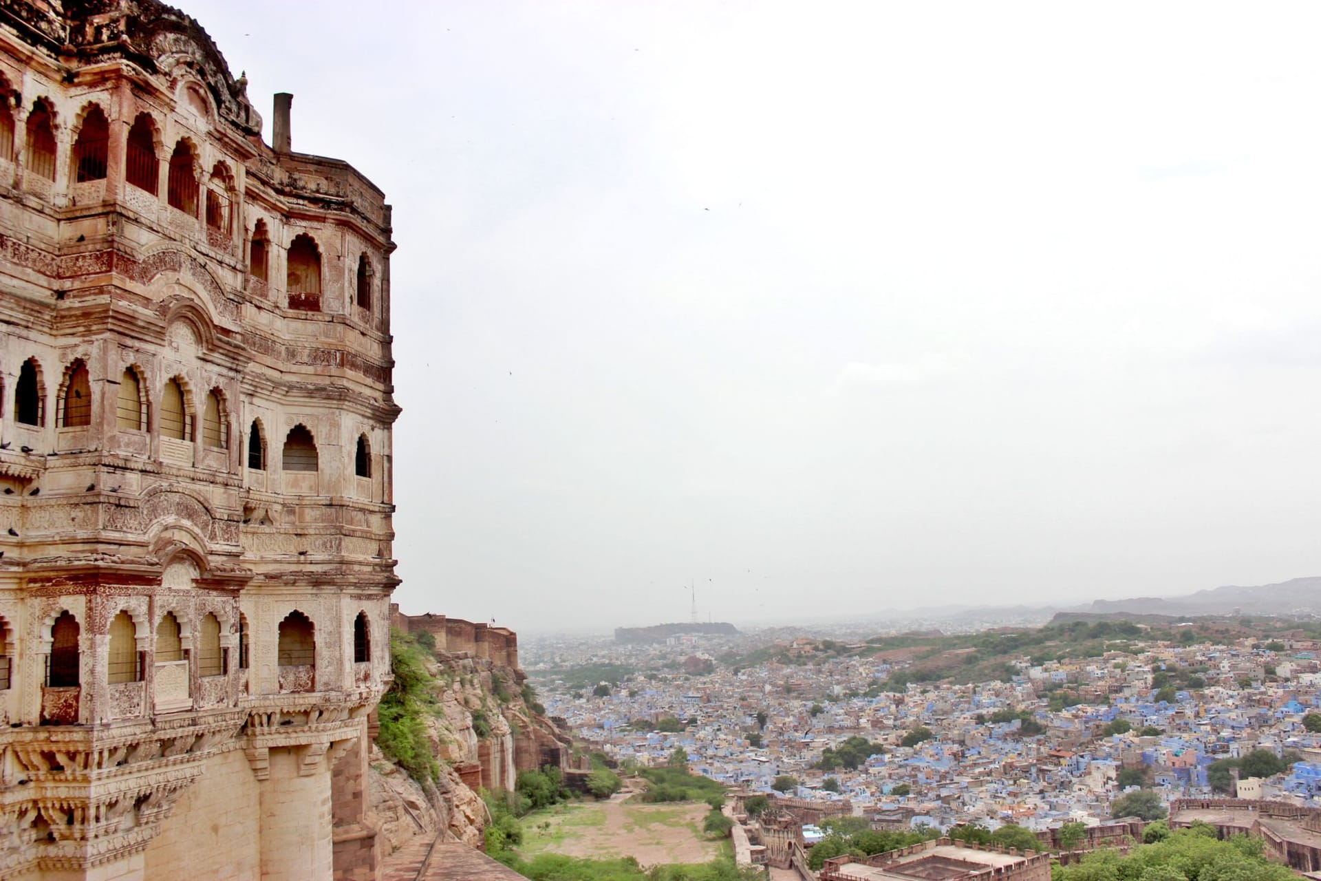 Jodhpur's blue-washed old city spreading below the massive walls of Mehrangarh Fort at golden hour