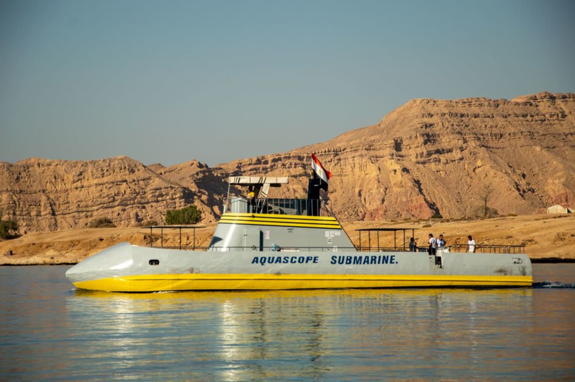 The turquoise bay of Naama Bay in Sharm El Sheikh with dive boats anchored offshore and the Sinai mountains behind