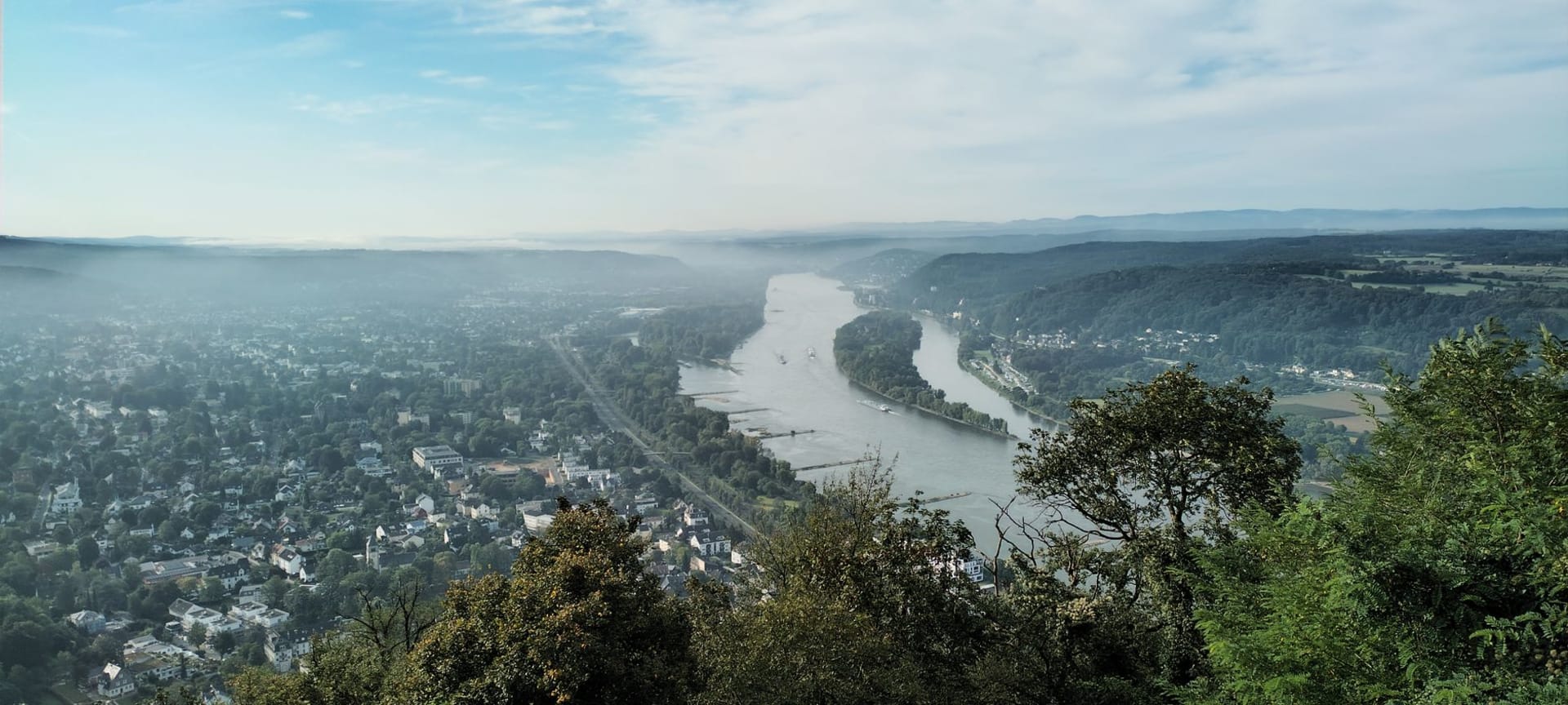 The Mäuseturm watchtower rising from a Rhine island at Bingen, the gorge entrance narrowing behind it
