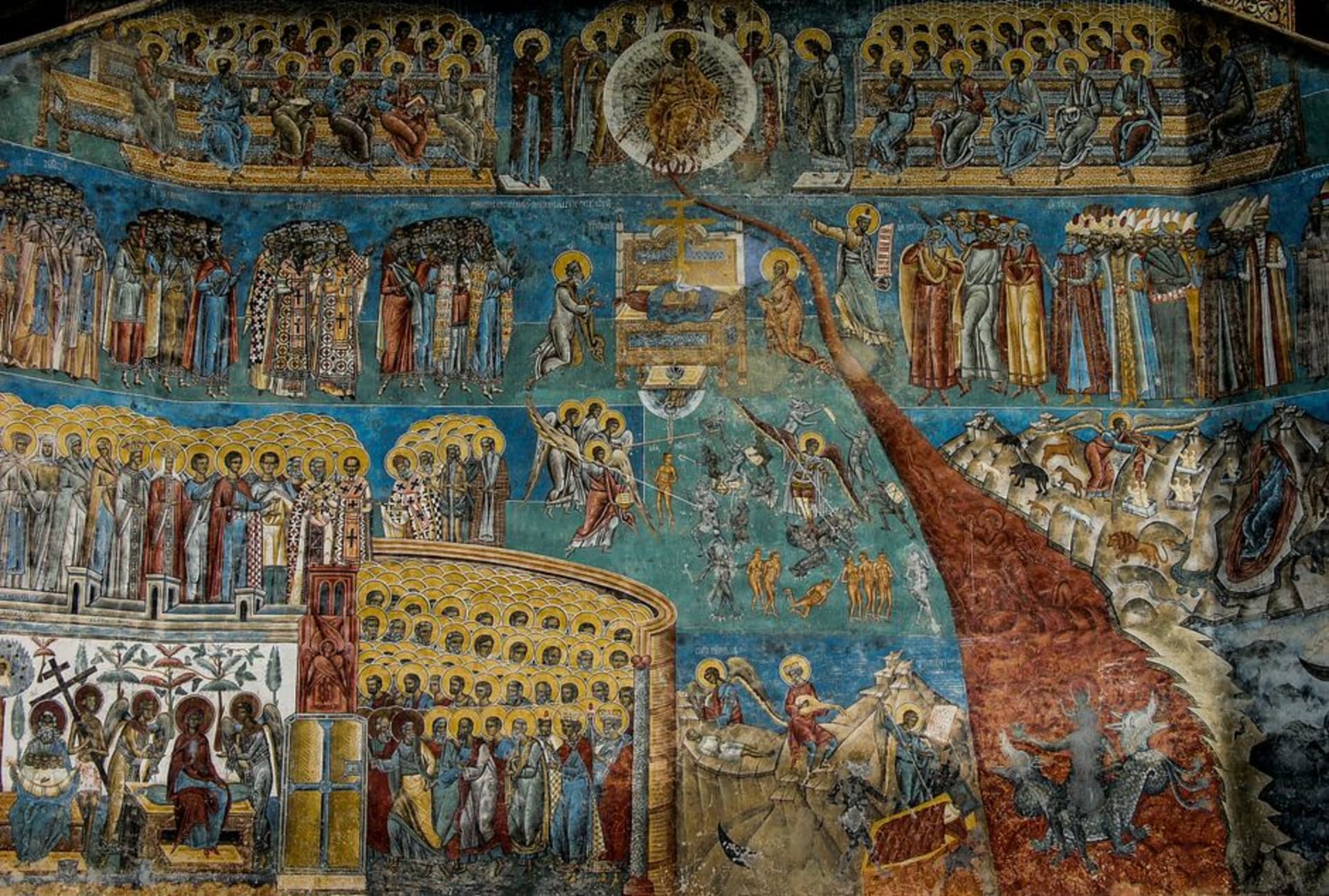 Exterior fresco-covered wall of a Bucovina painted monastery under a clear sky