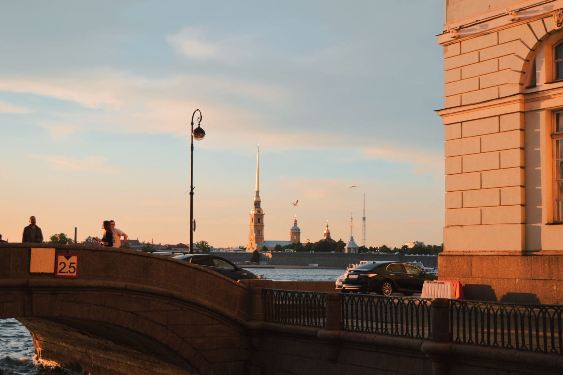 The Neva River embankment and the Palace Bridge bathed in the grey-gold light of a White Nights sky at 2 a.m. in June