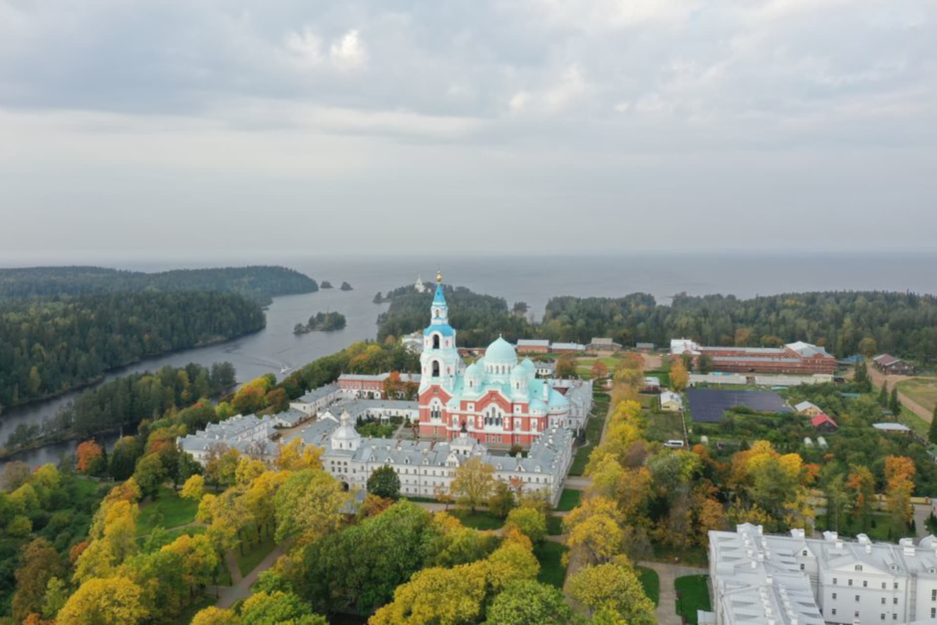 The green-and-white bell tower of Transfiguration of the Savior Monastery rising above Lake Ladoga