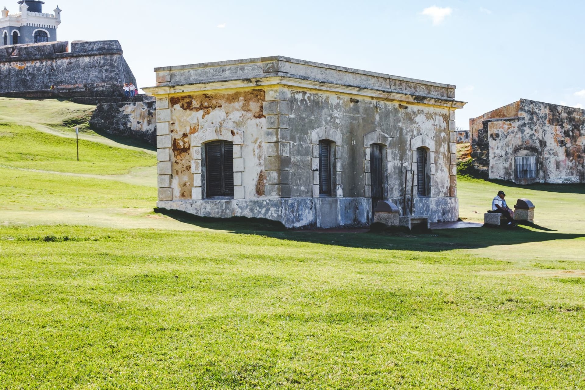 Brimstone Hill Fortress stone ramparts rising from a jungle-covered hillside with the Caribbean Sea far below