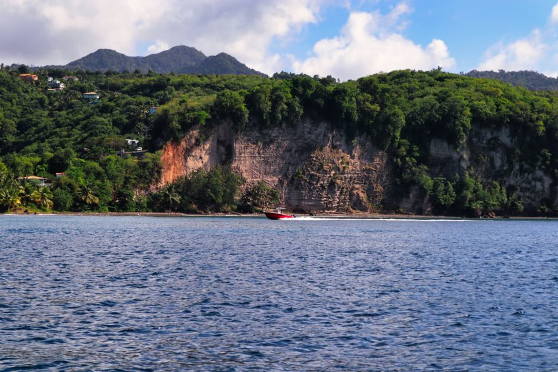 Barcos de pesca de madera pintados con colores vivos amarrados en el puerto de Dennery, en la costa atlántica de Santa Lucía
