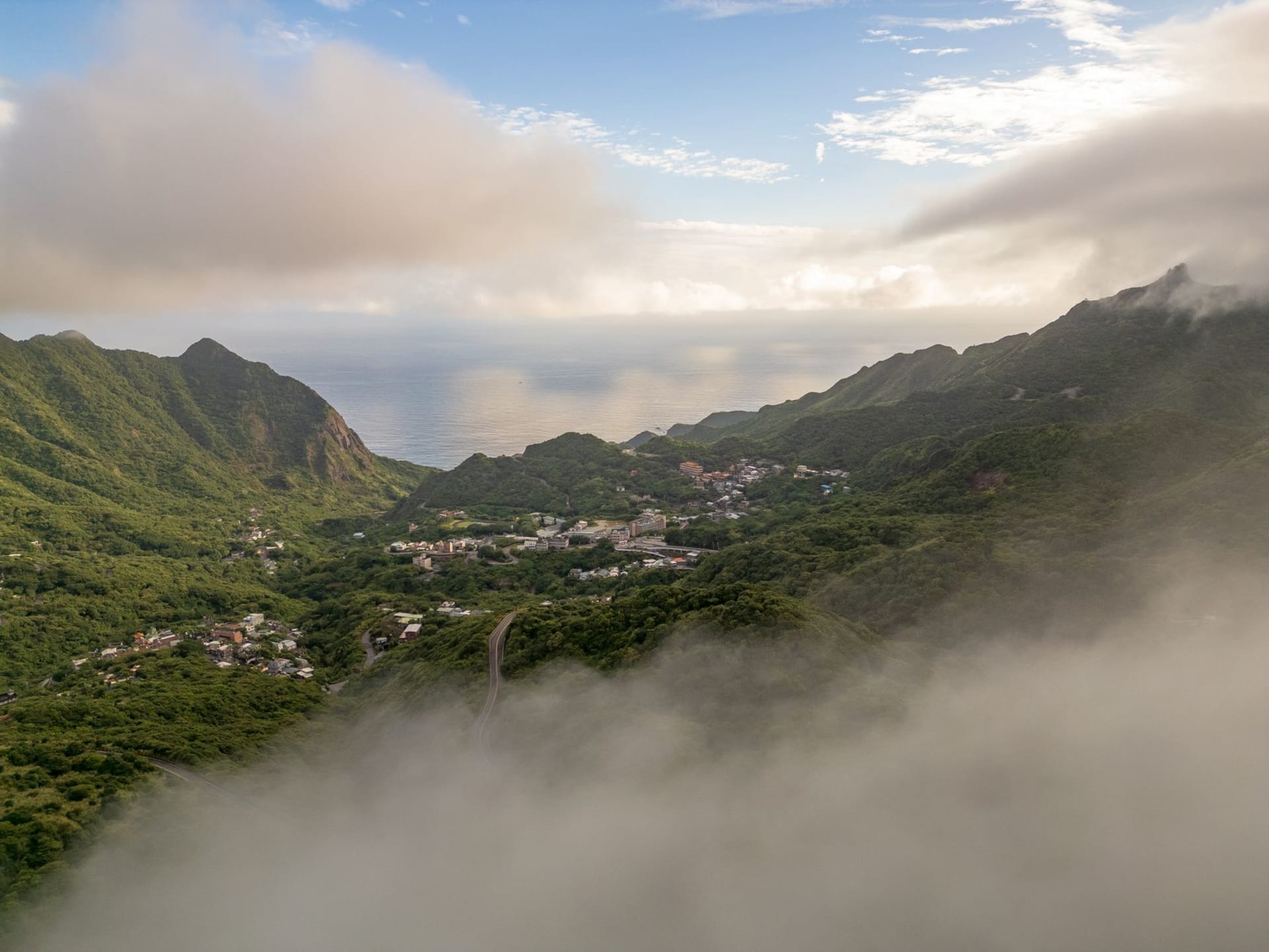 Soufrière town waterfront with colorful fishing boats and the twin Piton peaks rising dramatically behind