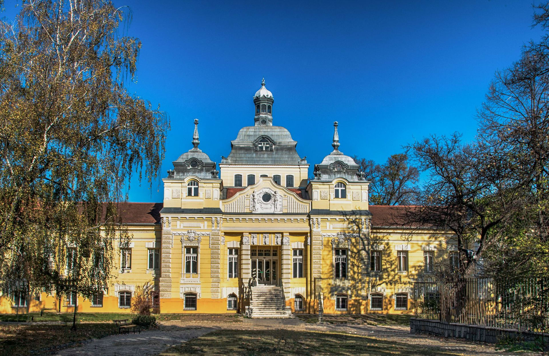 The white Venčac marble Church of St. George at Oplenac gleaming against a blue spring sky above the Šumadija hills
