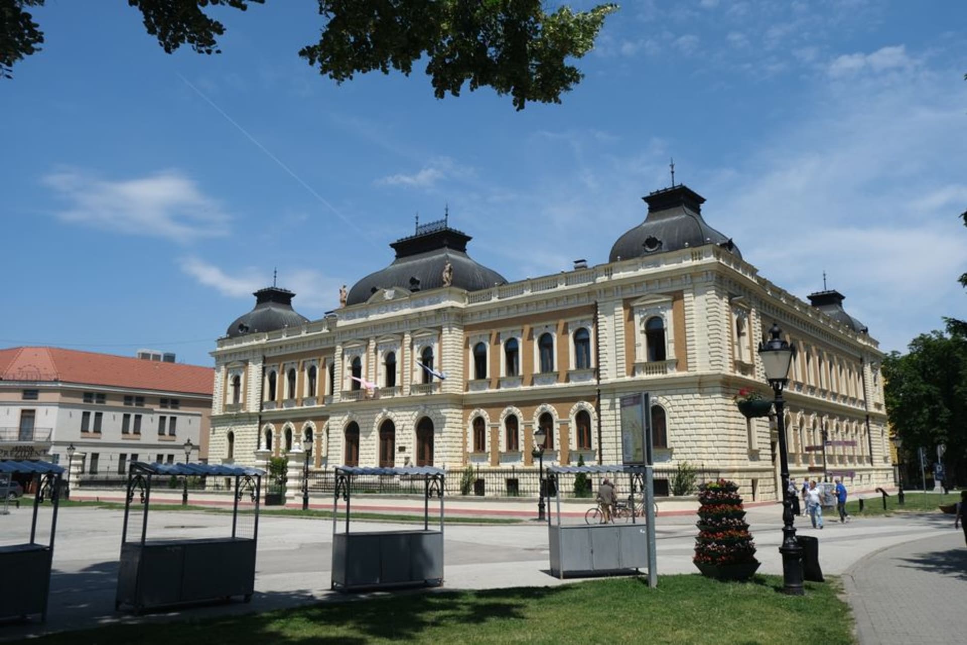 The baroque square of Sremski Karlovci with the Four Lions Fountain and twin-towered cathedral at golden hour