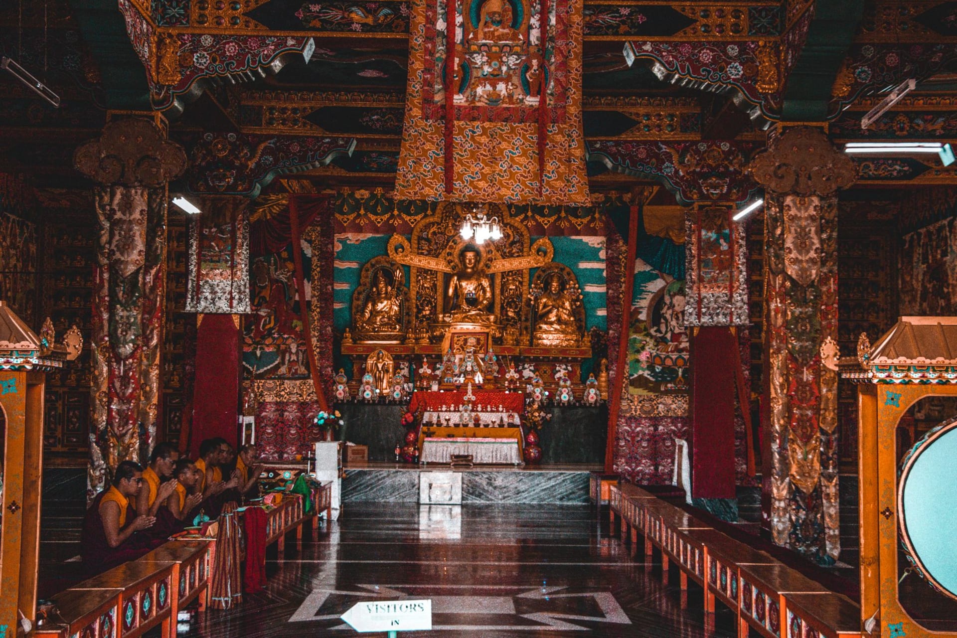 Norbugang coronation stone and ancient chorten in the sacred grove at Yuksom, dappled light through old oak trees