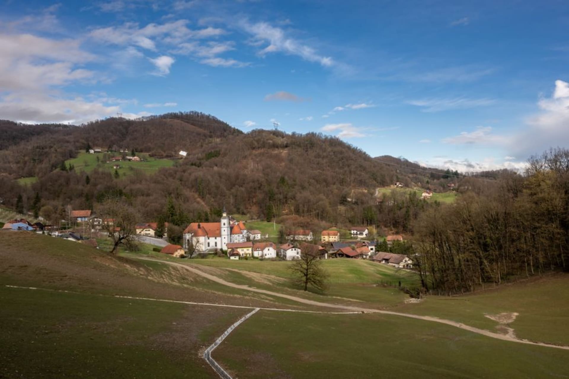 The wide open Transalpina Square straddling the border between Nova Gorica and Gorizia, with a mosaic marker on the pavement showing where Slovenia meets Italy