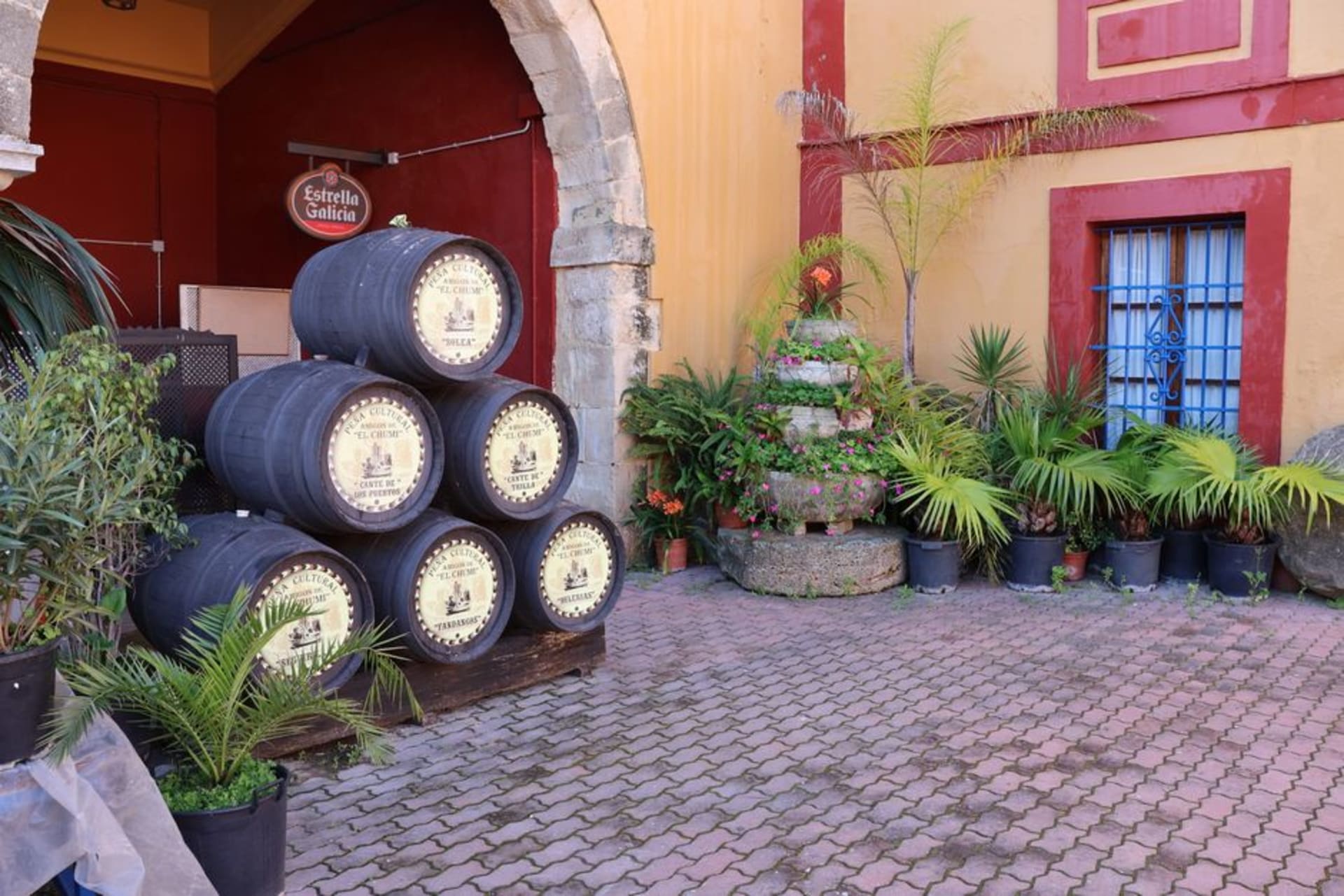 Rows of oak sherry barrels stacked in a dim, cathedral-like bodega in Jerez de la Frontera