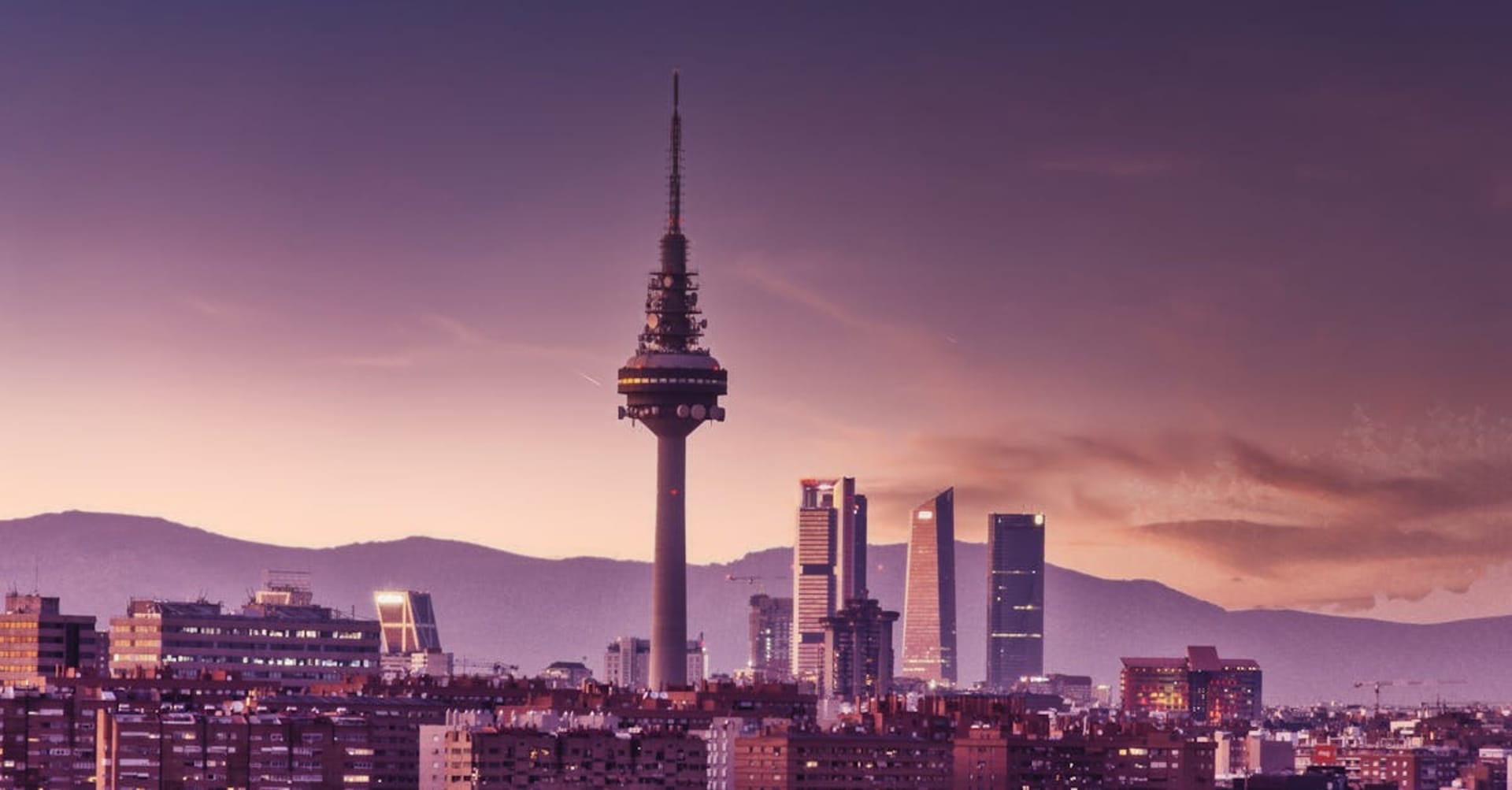 The grand fountain at Plaza de Cibeles illuminated at twilight in Madrid