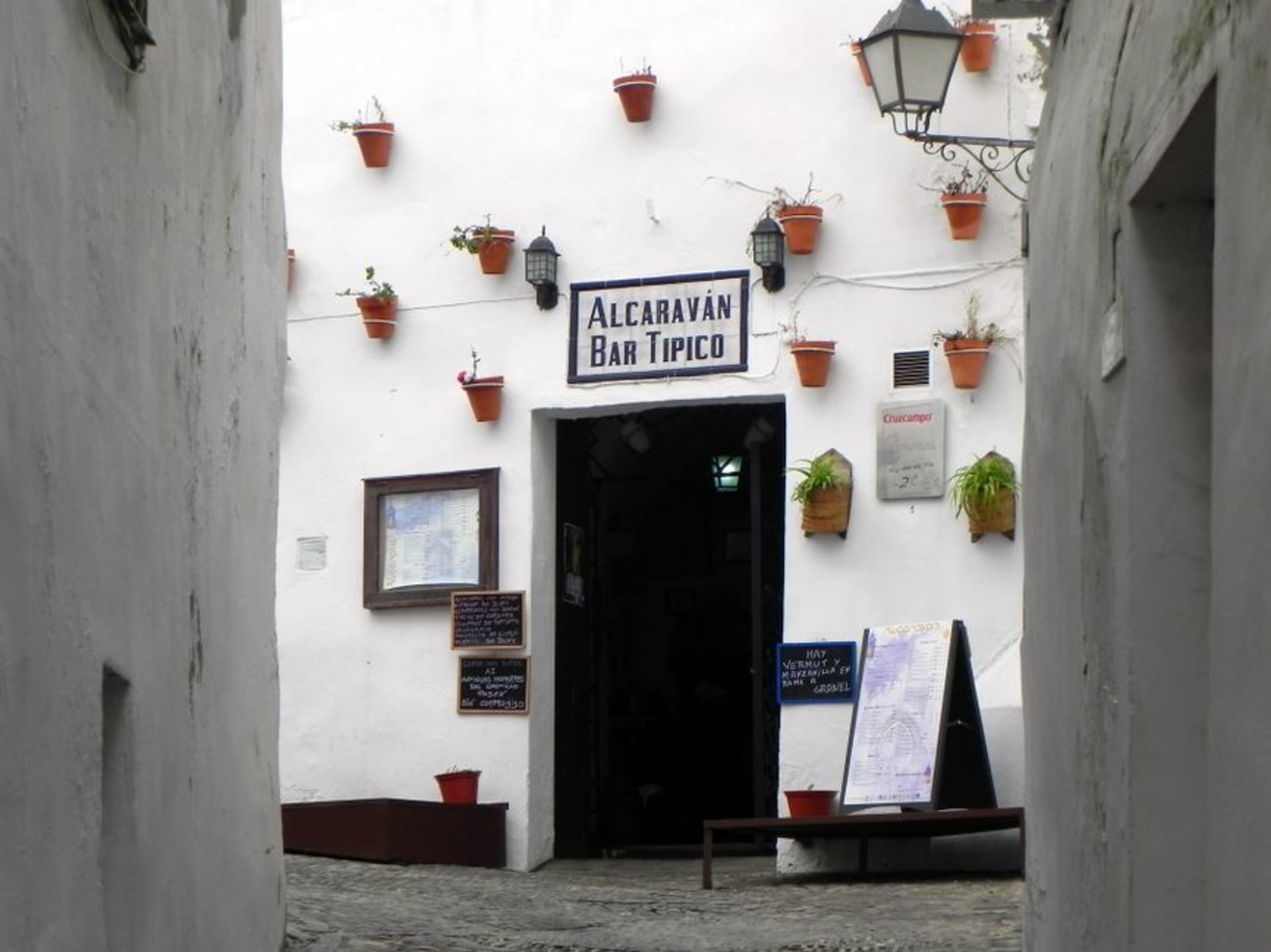 Arcos de la Frontera perched on its sheer limestone cliff above the Guadalete river, whitewashed houses stacked against the rock face