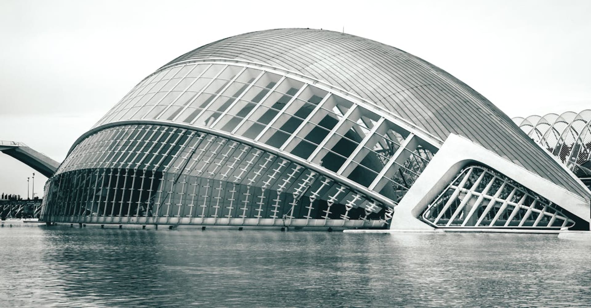 The futuristic City of Arts and Sciences reflected in still water at dusk in Valencia