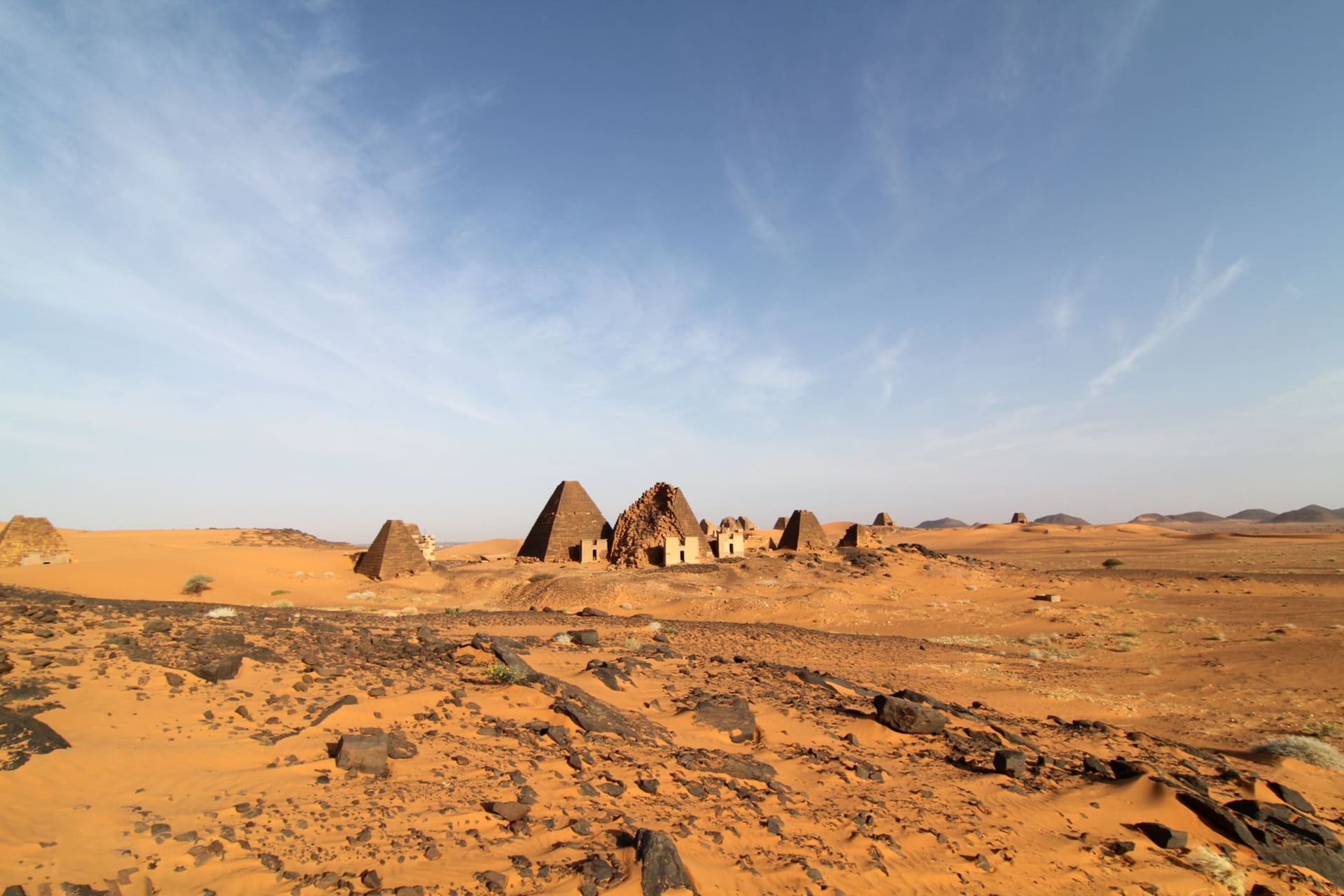 The sandstone pinnacle of Jebel Barkal rising from the desert floor with ancient Nubian temple ruins at its base, near Karima, Sudan