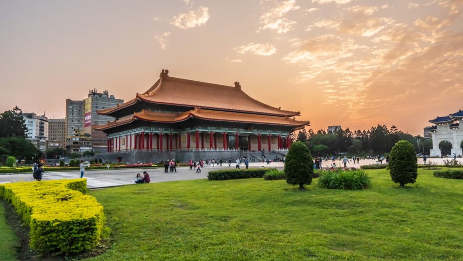 The green-tiled, palace-style facade of the National Palace Museum set against wooded hills on the outskirts of Taipei