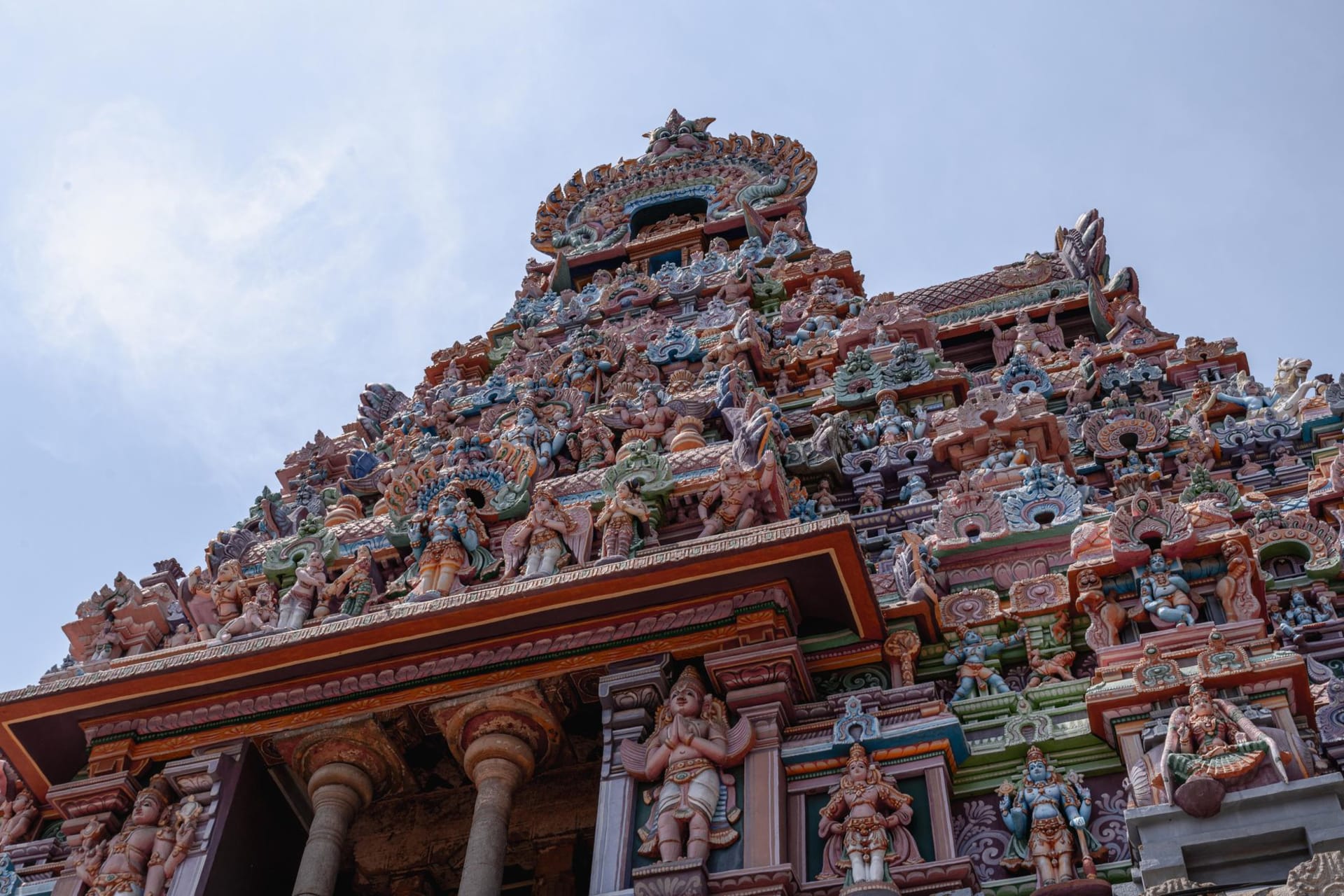 A crumbling Chettiar mansion courtyard in Karaikudi, Italian marble floors and Belgian glass windows visible through teak doors opened to the dry heat