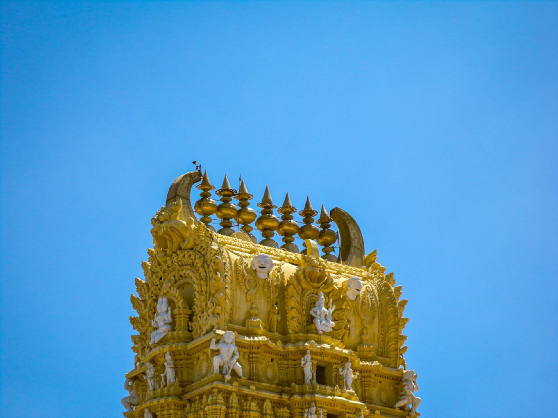 The Brihadisvara Temple tower of Gangaikonda Cholapuram rising above green fields at dusk