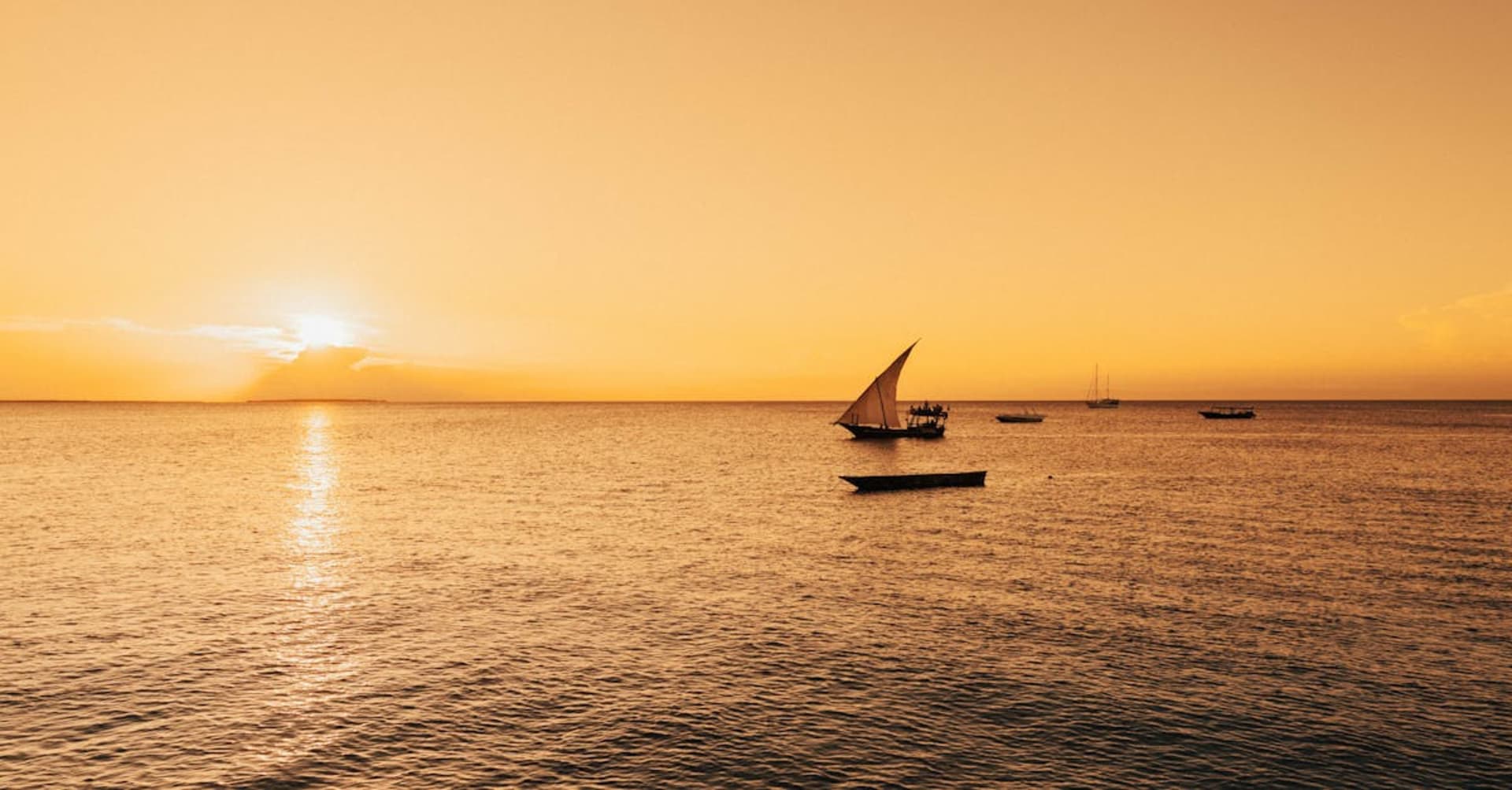 Traditional dhow sailing boat on turquoise waters off the Zanzibar coast