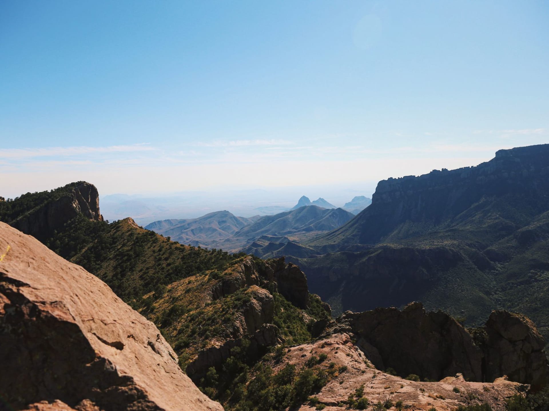 Rugged mountain terrain of Big Bend National Park under a wide clear blue sky