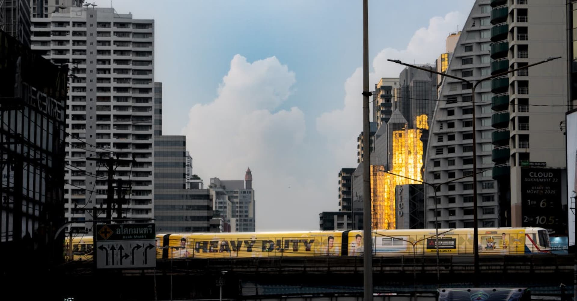 Golden temples rising above the bustling streets of Bangkok at sunset