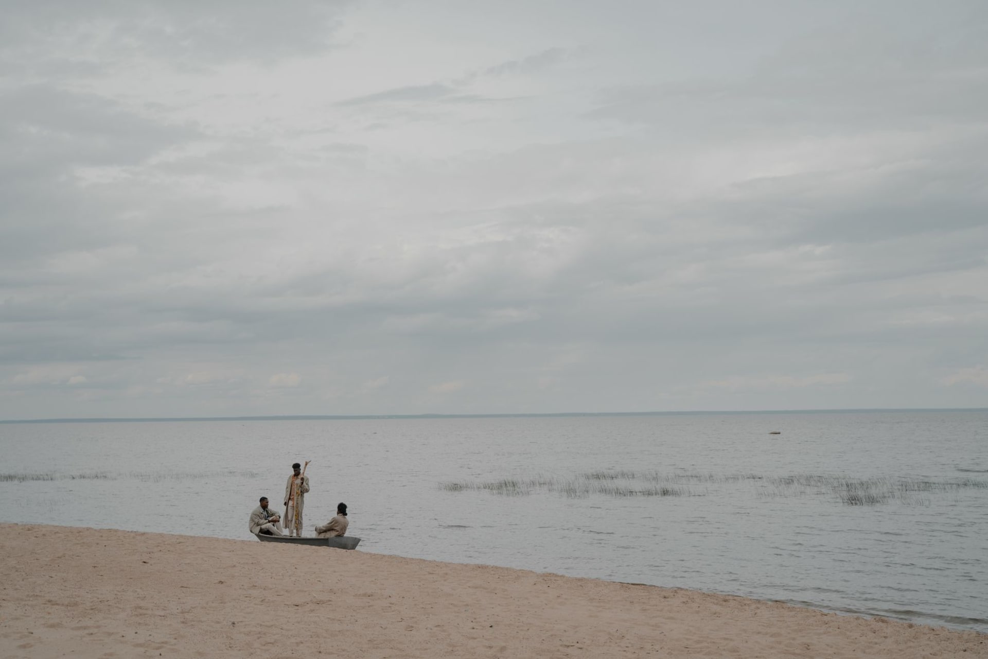 Weathered colonial buildings beside the lagoon in Aného under a hazy coastal sky