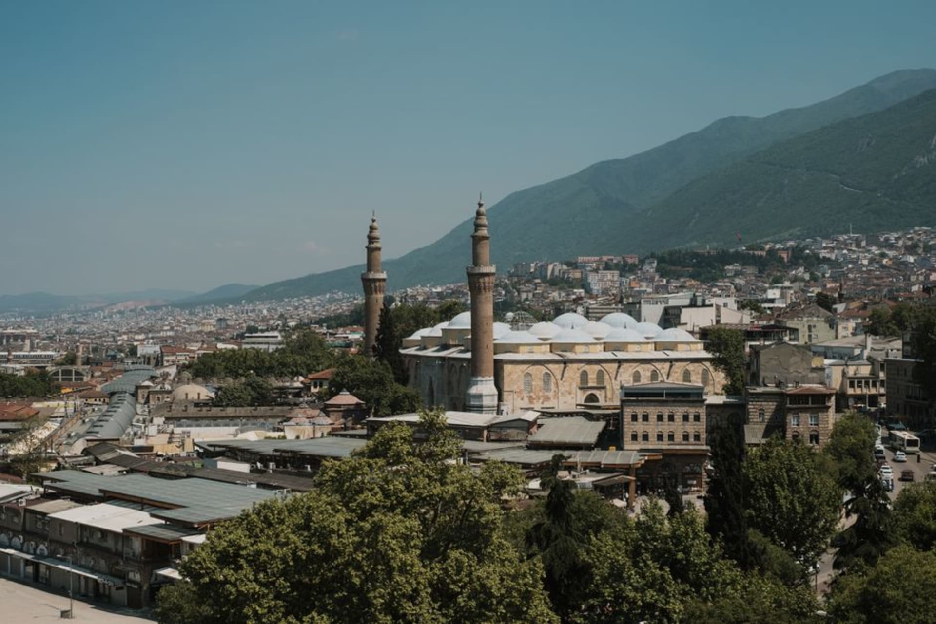 The green domes and minarets of Ulu Camii rising above Bursa's old town, with Uludağ mountain behind