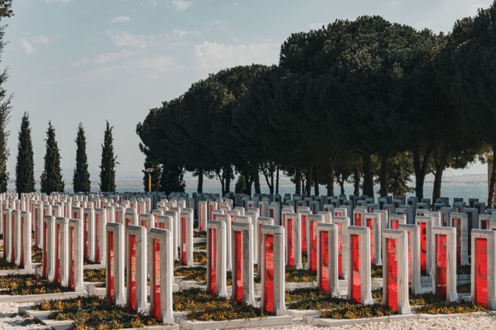 Rows of white gravestones at an Allied war cemetery on the Gallipoli peninsula overlooking the strait