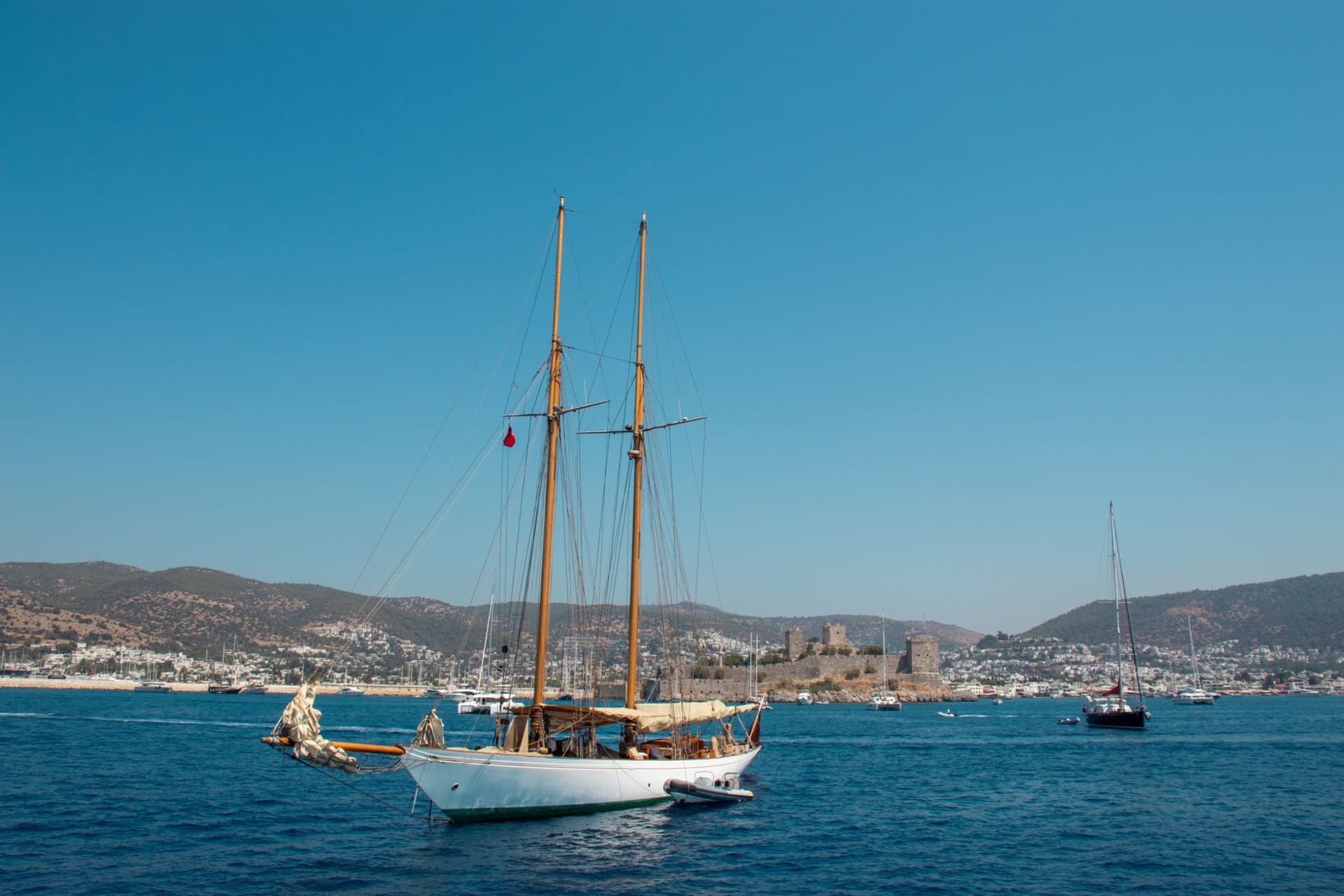 Bodrum Castle of St Peter from the harbor, white yachts moored below its battlements in deep blue Aegean water