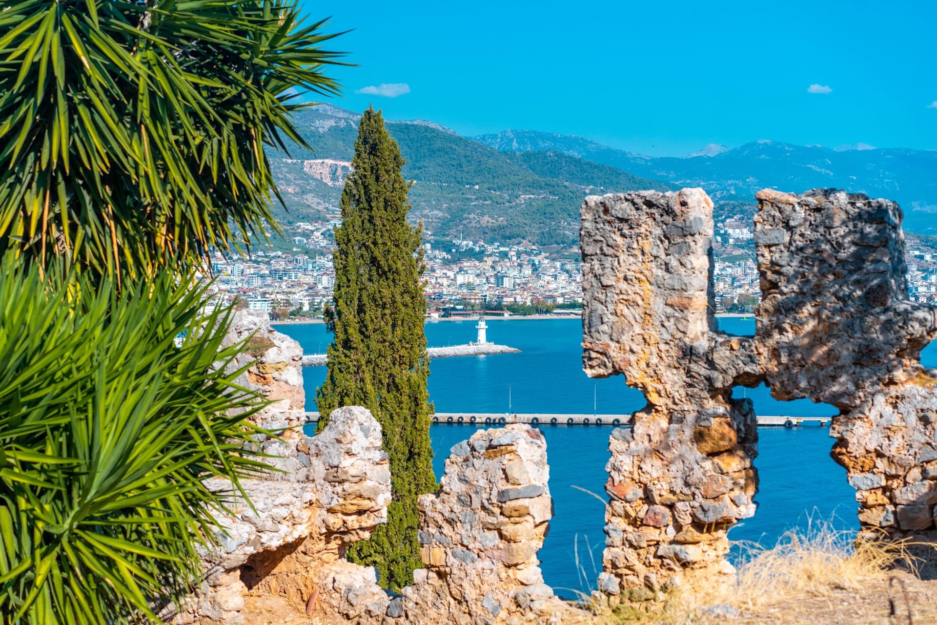 Panoramic view of Alanya's turquoise coastline seen from the weathered stone walls of the ancient hilltop fortress