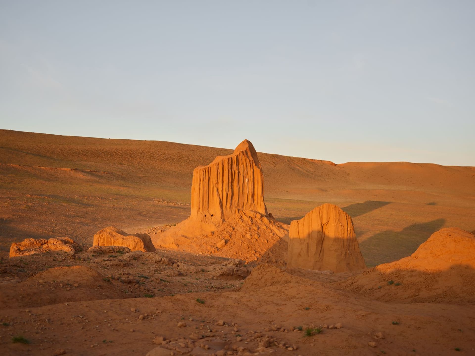 The domed mausoleum of Sultan Sanjar rising from flat ochre desert at ancient Merv