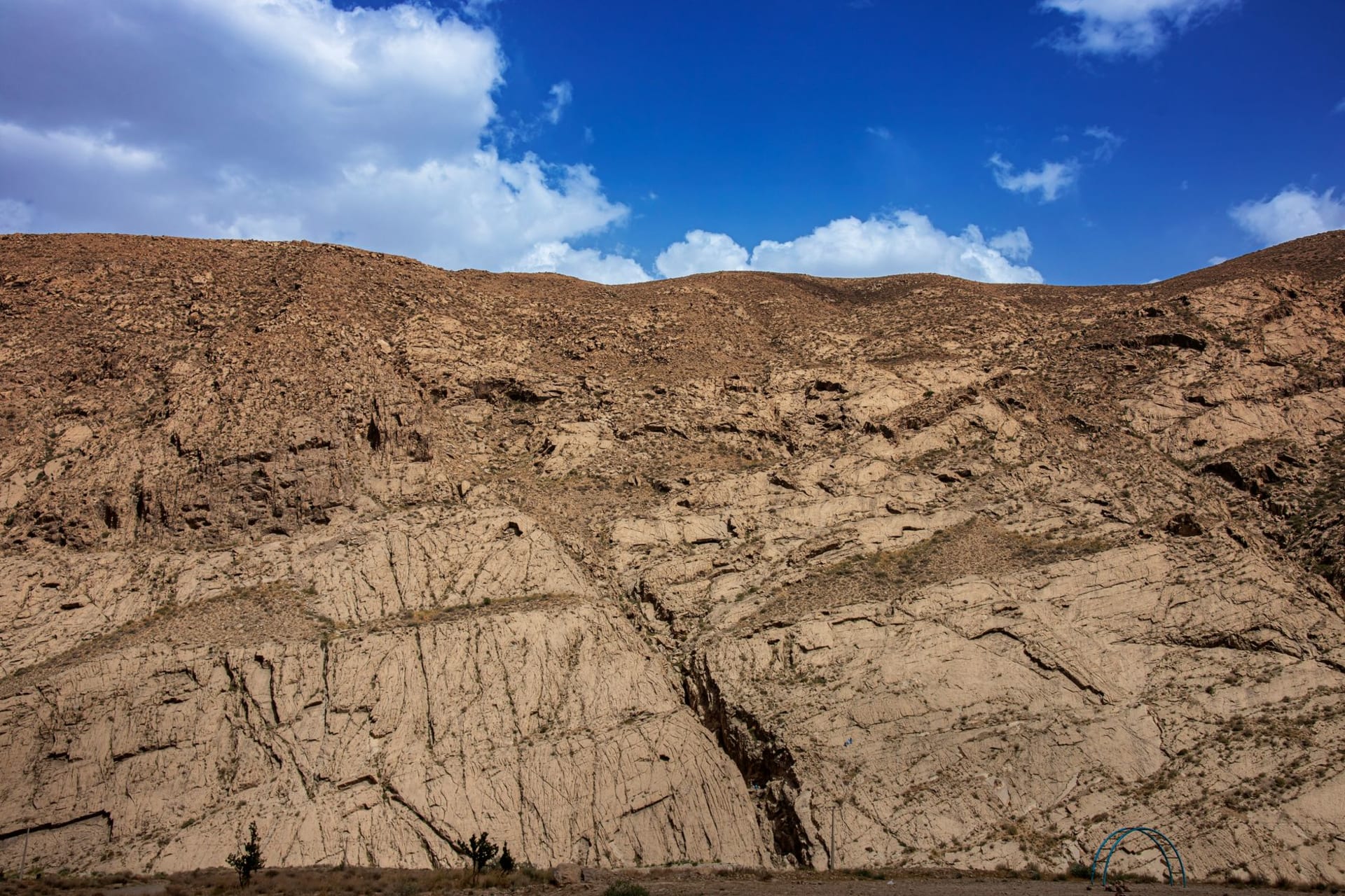 Yangykala Canyon at sunset, striated red and ochre cliffs descending into a vast dry gorge in western Turkmenistan